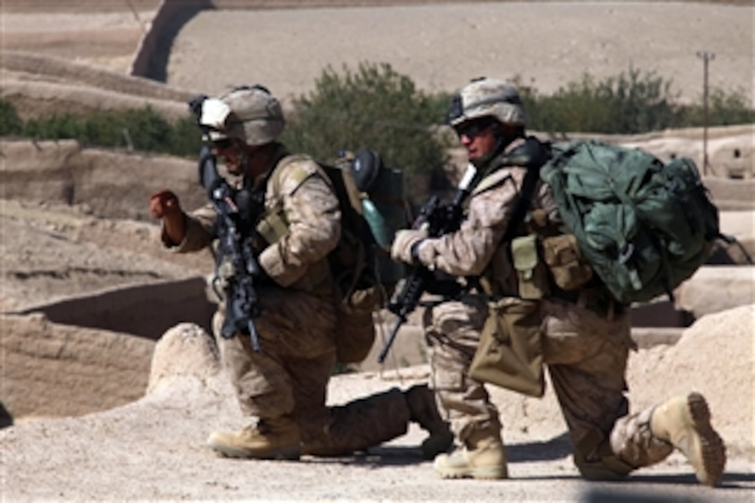 U.S. Marine Corps Lance Cpl. Jose Maldonado (left) and Cpl. Rocco Urso (right), both with India Company, 3rd Battalion, 5th Marine Regiment, Regimental Combat Team 2, provide over watch security during an operation in Sangin Valley, Afghanistan, on Oct. 7, 2010.  The Marines conducted a two-day operation to clear insurgents from the Wishtan area.  