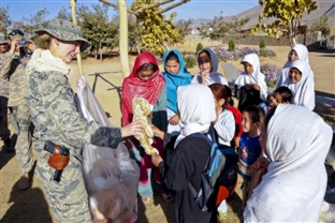 U.S. Air Force 1st Lt. Katherine Roling hands out toys donated in part from Vance Air Force Base, Okla., to girls at the girls' orphanage in Sanga Masha village in Afghanistan's Jaghori district, Oct. 12, 2010. Roling is a public affairs officer assigned to the Ghazni Provincial Reconstruction Team, whose members flew to the remote district to check on projects and visit the girls' orphanage.