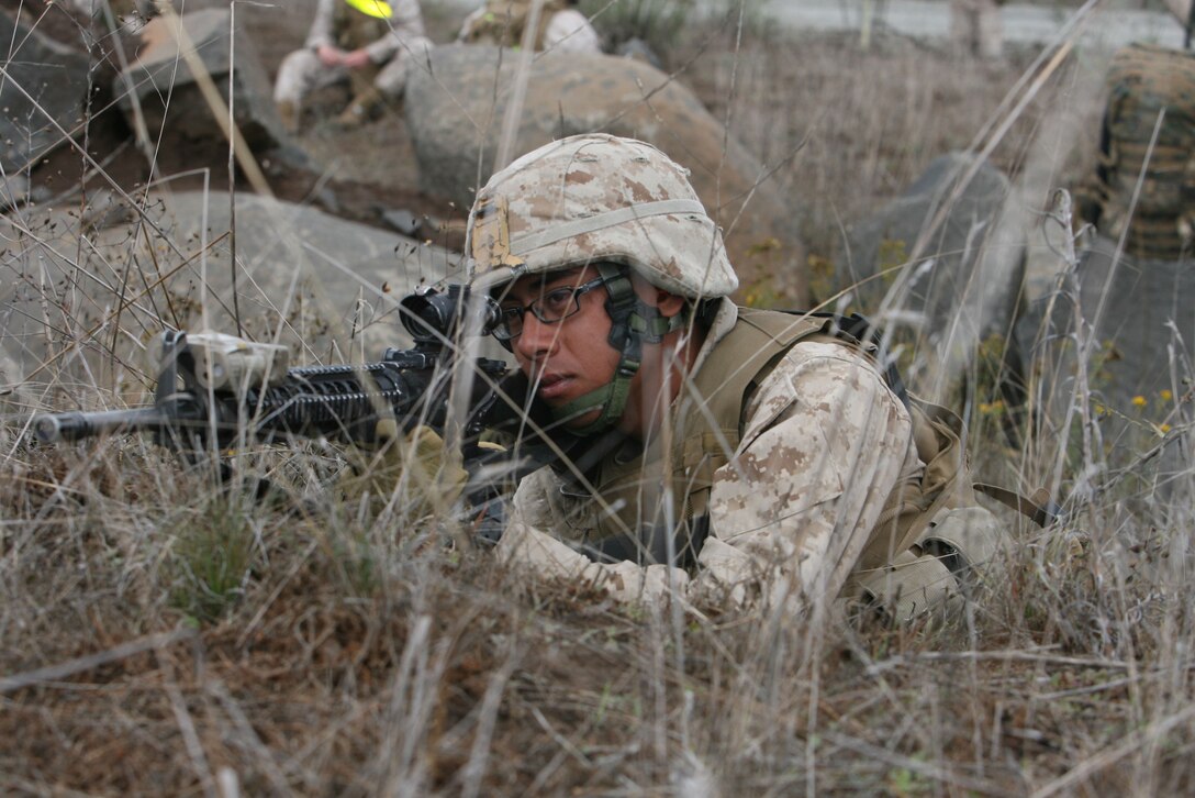 Lance Cpl. Elliott Delrio, 20, from Anaheim, Calif. a rifleman with Golf Company, 2nd Battalion, 5th Marine Regiment, 1st Marine Division, provides security at a landing zone during a live-fire helicopter raid on the hills northeast of camp San Mateo, Oct 20. The training enhanced the skills of Marines and sailors while attacking and moving under fire.