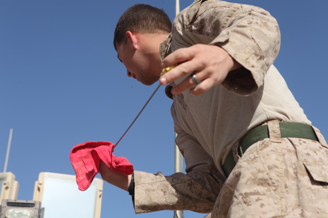 Cpl. Marshall Brennan, a tactical vehicle operator with Marine Wing Support Squadron 373, checks the fluid levels on his Mine Resistant Ambush Protected vehicle at the motor pool lot here Oct. 20 after convoying from Camp Leatherneck. The vehicle was cleaned and received preventative maintenance upon arrival and is prepared to continue further convoy operations the following morning.  The MWSS-373 motor transport Marines provide logistical support for 3rd Marine Aircraft Wing (Forward) throughout Afghanistan.