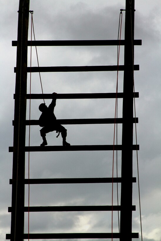 A recruit from Platoon 1085, Company D climbs to the top of the "Stairway to Heaven," an obstacle in the Confidence Course during the Crucible. The Crucible is a 54-hour training event conducted during Marine Corps Recruit Training at Edson Range, Marine Corps Base Camp Pendleton, Calif. The Crucible requires Marine recruits to overcome mentally and physically-demanding obstacles as a team.