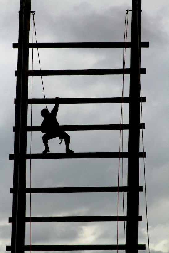 A recruit from Platoon 1085, Company D climbs to the top of the "Stairway to Heaven," an obstacle in the Confidence Course during the Crucible. The Crucible is a 54-hour training event conducted during Marine Corps Recruit Training at Edson Range, Marine Corps Base Camp Pendleton, Calif. The Crucible requires Marine recruits to overcome mentally and physically-demanding obstacles as a team.