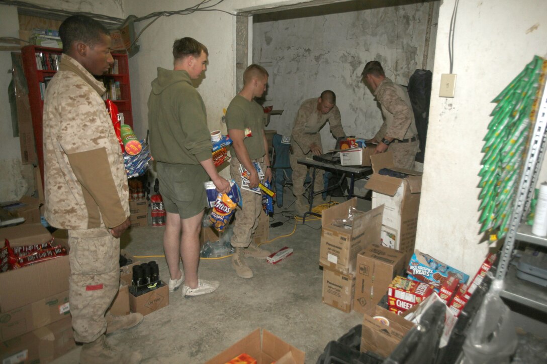 U.S. Marines assigned to India Battery, 3rd Battalion, 12th Marine Regiment form a line in the mobile post exchange that was set up by Marine Corps Community Services Marines with Headquarters and Service Company, 1st Marine Logistics Group (Forward), aboard Forward Operating Base Zeebrugge, Kajaki, Afghanistan, Oct. 20. The mobile PX travels round to different forward operating bases in Helmand province to sell hygiene items, supplements and various different snacks to help boost morale.