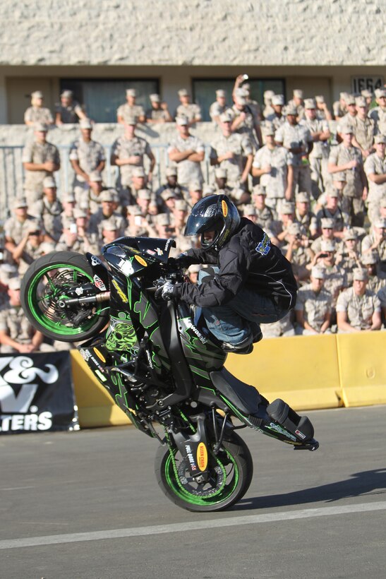 Tony Carbajal, a freestyle motorcycle stunt rider, who performed with others at the Marine Corps Communication-Electronics School’s annual safety fair, does a wheelie for students Oct. 22, 2010 behind their barracks. Aside from the dazzling performance, the students also received well-needed lessons in safety.::r::::n::
