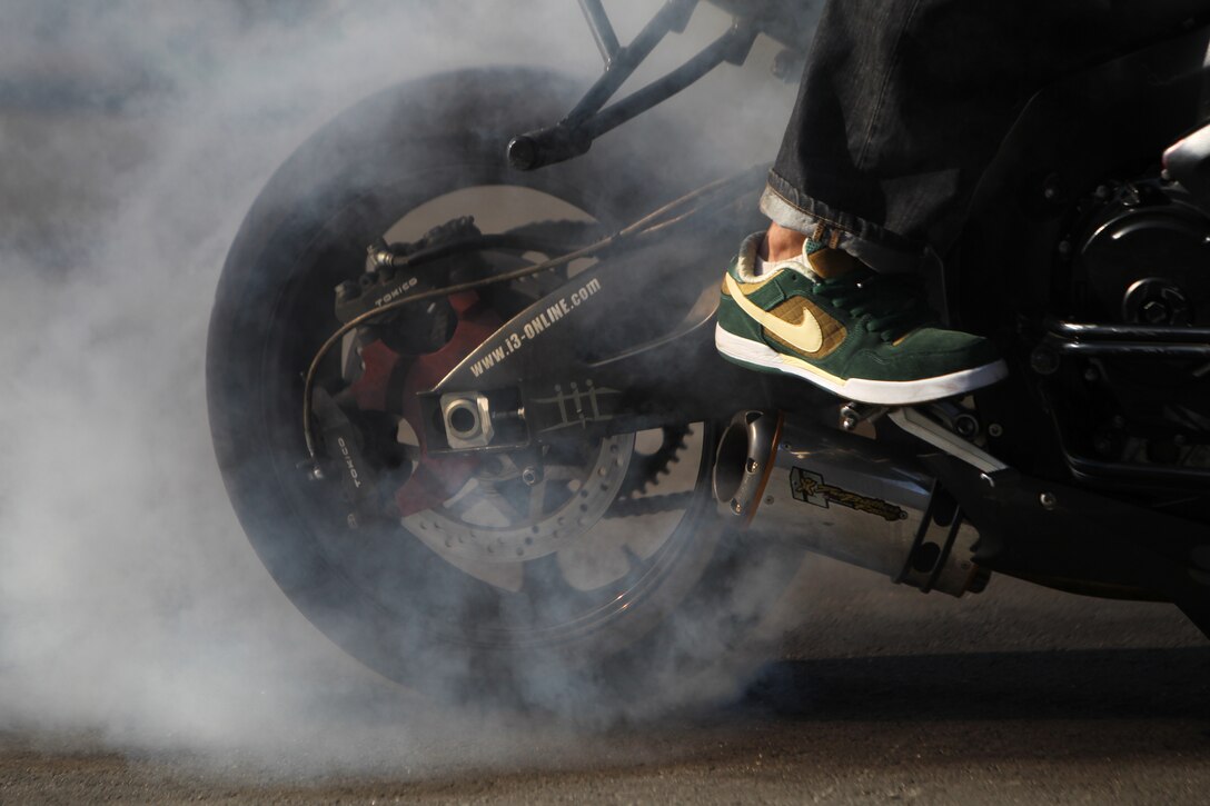 Tony Carbajal, a freestyle motorcycle stunt rider, who performed with others at the Marine Corps Communication-Electronics School’s annual Safety Fair, does a burnout for students Oct. 22, 2010 behind their barracks. Aside from the dazzling performance, the students also received well-needed lessons in safety.::r::::n::