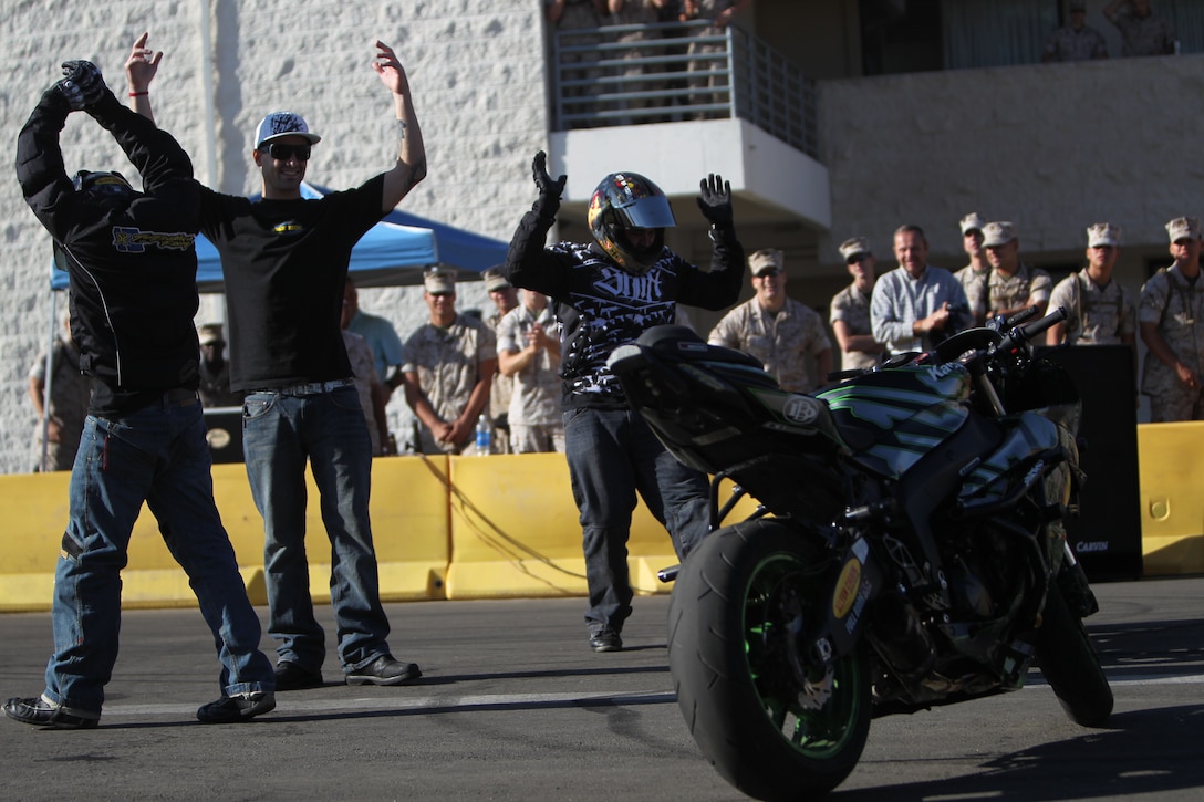 Freestyle motorcycle riders performing at the Marine Corps Communication-Electronics School Oct. 22, 2010, for their annual Safety Fair, celebrate after a round of the show behind the school’s student barracks. The show also doubled as an alternative safety brief.::r::::n::