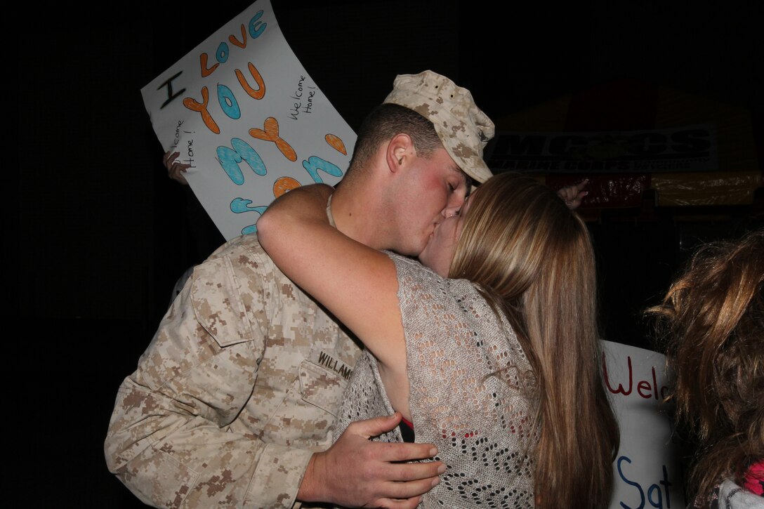 Lance Cpl. Robert Williamson, a tank crewman with Alpha Co., 1st Tank Battalion, passionately kisses his wife, Stephaney, after his seven-month deployment with 3rd Combat Engineer Battalion to Afghanistan at the advanced party’s homecoming Oct. 20, 2010.::r::::n::