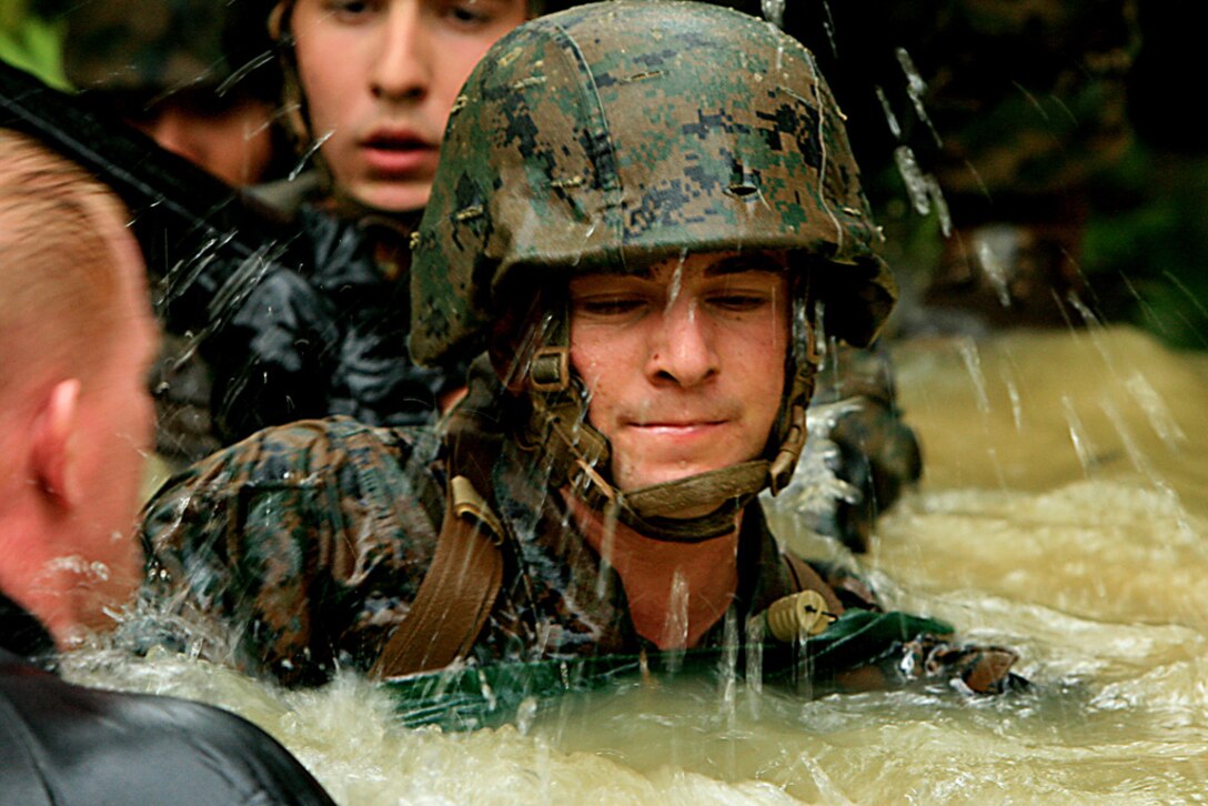 Lance Cpl. Andrew Cortes, a field artillery cannoneer with Battery B, 12th Marine Regiment, 3rd Marine Division, III Marine Expeditionary Force, prepares to go under a 15-feet underwater obstacle known as the pond, traveling through a pipe, during the endurance course portion of the jungle survival skills course at the Jungle Training Survival Center, Oct. 21. The artillery trained Marines became familiar with jungle survival skills by learning how to gather their own food, making fire from scratch, land navigation, combat patrolling, building an expedient shelter, and repelling.