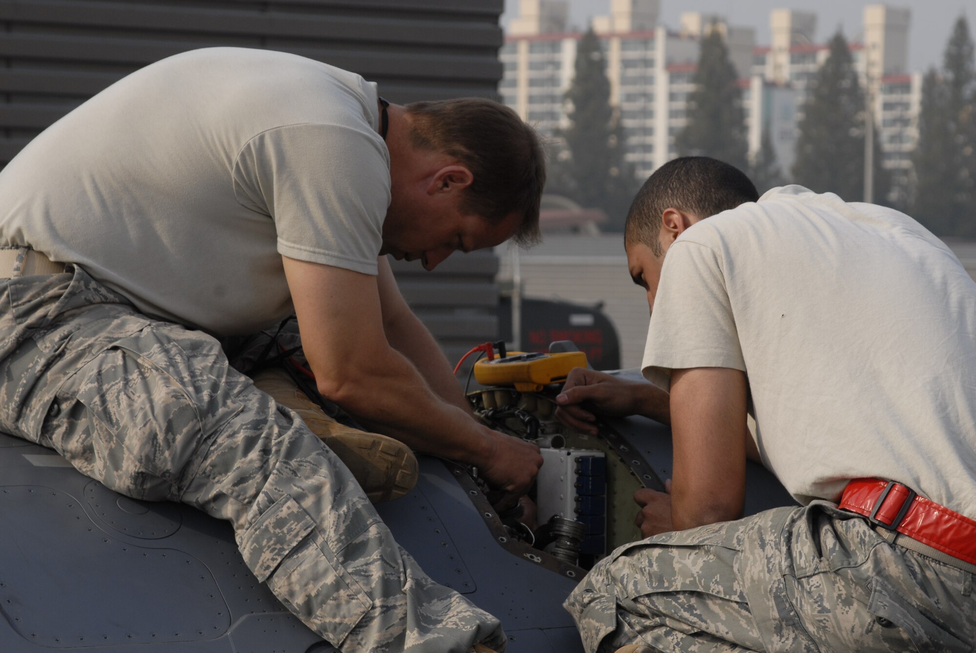 Maj. Daniel Mattioda, 8th Maintenance Squadron, left, and Staff Sgt. Matthew Wilkerson, 51st Aircraft Maintenance Squadron, troubleshoot an electrical system problem in an Osan F-16 Fighting Falcon Oct. 20 during exercise Max Thunder 10-2 at Kwangju Air Base, Republic of Korea. Major Mattioda is prior-enlisted with an electrical environmental background. (U.S. Air Force photo/Staff Sgt. Eric Burks)