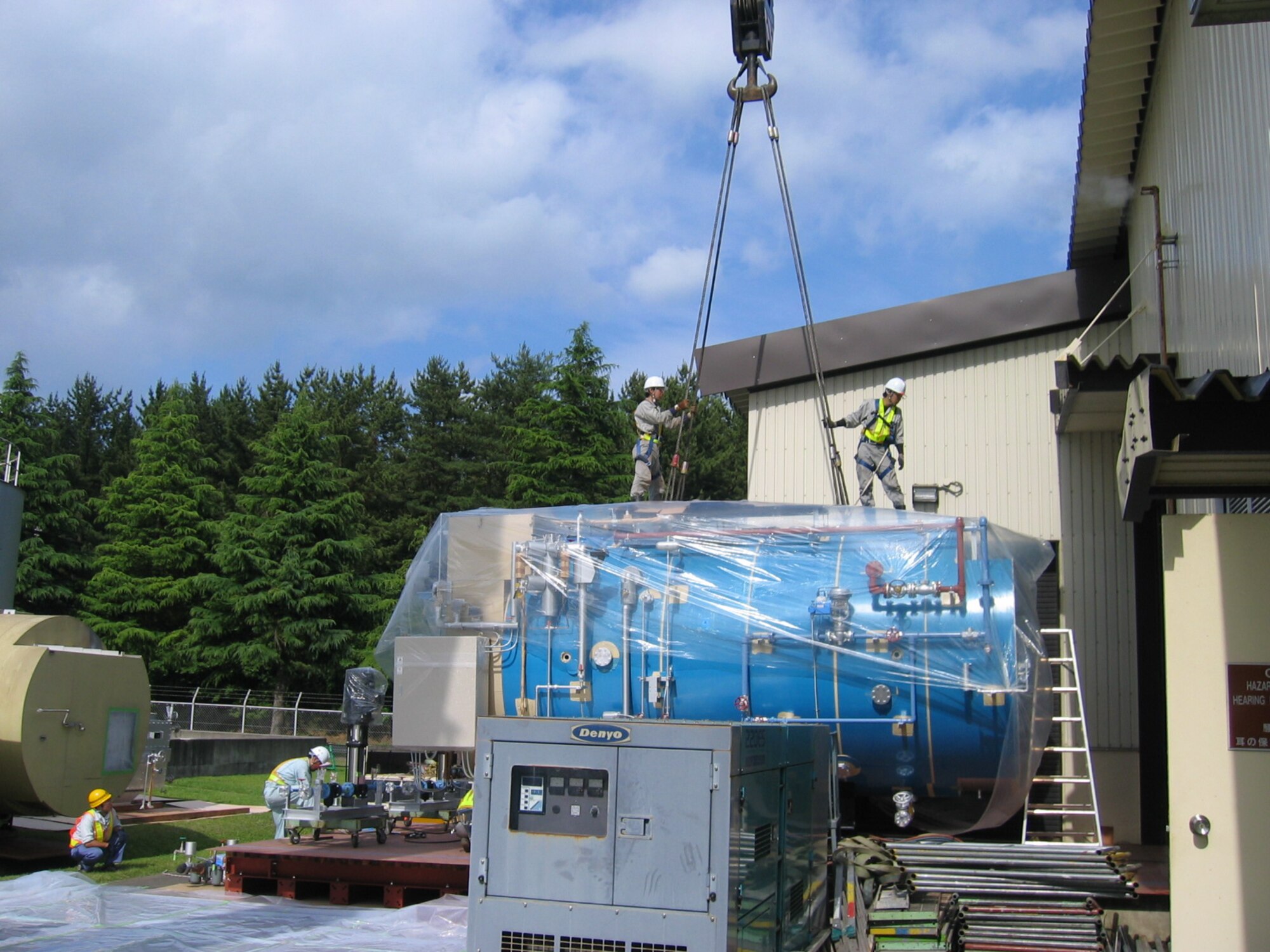 Japanese contractors install one of three new boilers in the Misawa Air Base, Japan, North housing area. The three recently-installed, digitally-controlled boilers replaced four 1980s models. The new boilers have added performance-enhancing features that will produce an overall 10-percent increase in efficiency for the base. (Courtesy photo)