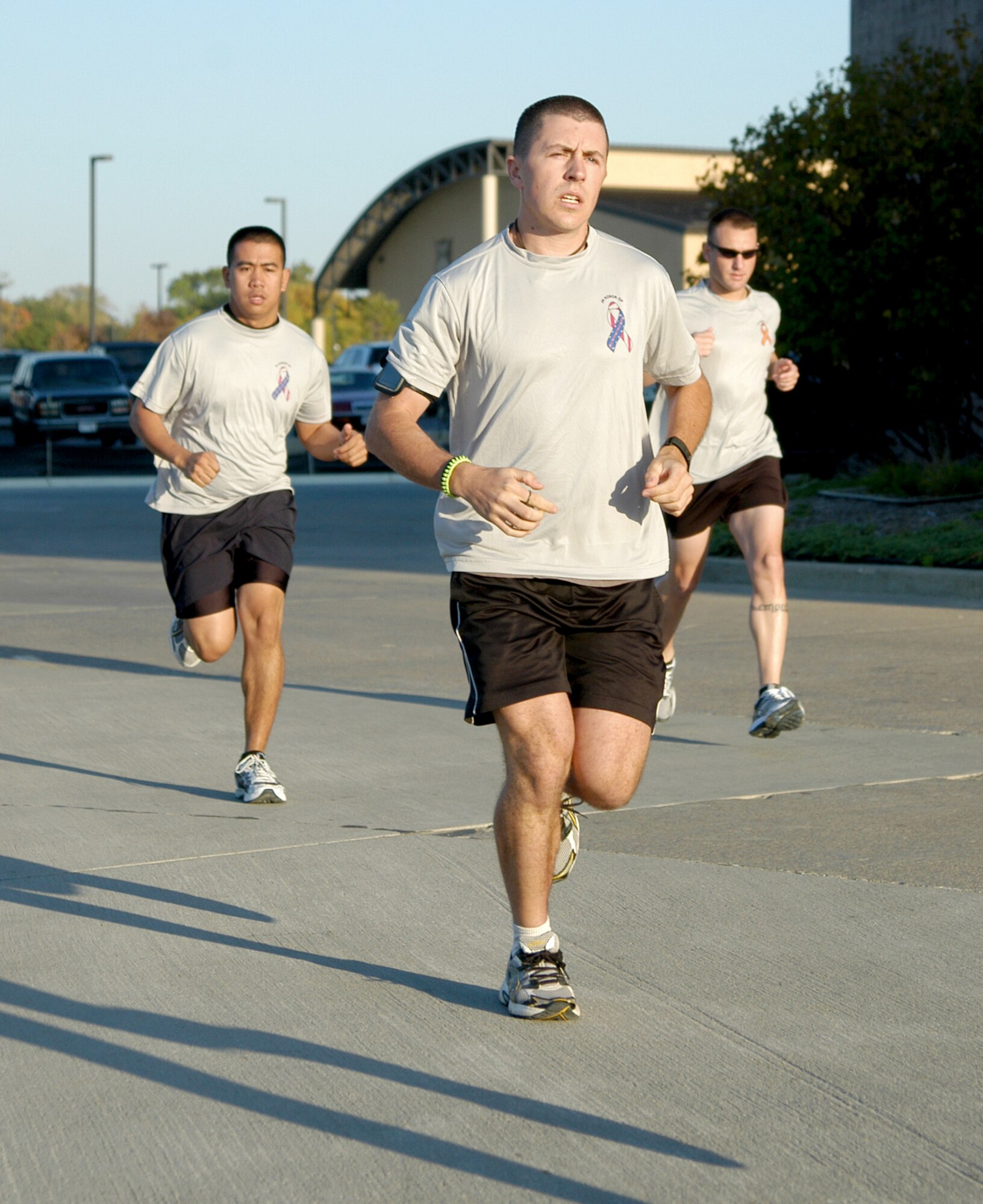 Airman 1st Class David J. Smith (front), Airman 1st Class Wilson Delos Trino (left), and Master Sgt. Johnathan M. Ward begin a 9-mile run Oct. 8, 2010, at Offutt Air Force Base, Neb. Airman Smith is a fitness specialist with the 55th Force Support Squadron. Airman Trino is a force management operations technician with the 55th FSS. Sergeant Ward is a Personnel Reliability Program monitor for the 55th Security Forces Squadron. All three are members of the 55th FSS marathon running team. (U.S. Air Force photo/Staff Sgt. James M. Hodgman)