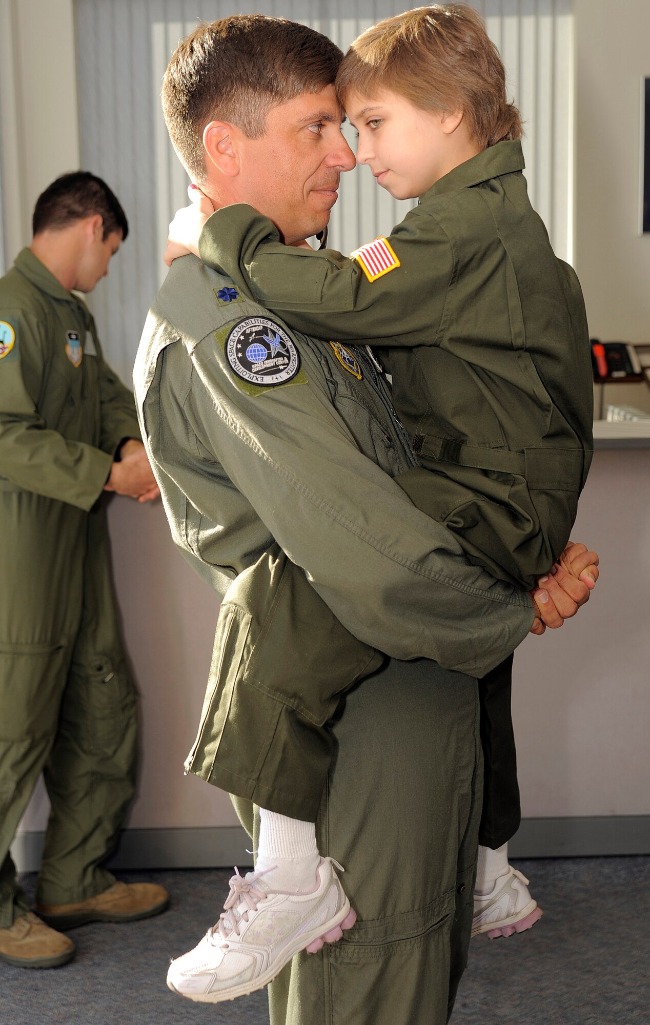 Lt. Col. Chris Stratton and his daughter, Caroline, share a private moment during the family's visit to the Air Force Academy Oct. 15. Caroline, 11, was named the Academy's cadet for a day. Colonel Stratton is assigned to the Space Innovation and Development Center at Schriever Air Force Base. (U.S. Air Force photo/J. Rachel Spencer)
