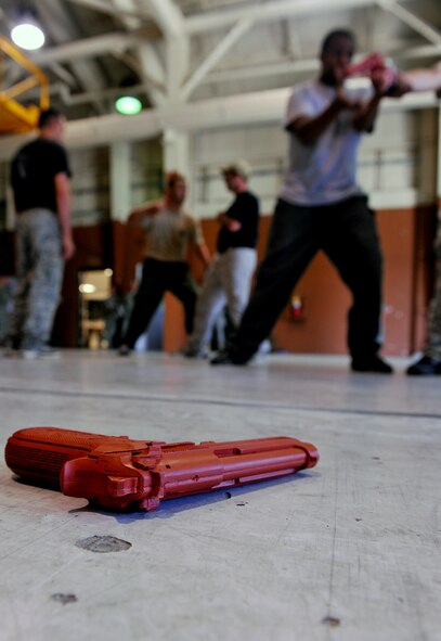 MOODY AIR FORCE BASE, Ga. -- A training pistol lies on the floor during a Krav Maga training class with the Lowndes County Sheriff’s Department Special Weapons and Tactics team here Oct. 14. One of the techniques taught by 822nd Base Defense Squadron members during the training was successfully disarming an attacker without being harmed. (U.S. Air Force photo/Airman 1st Class Joshua Green)
