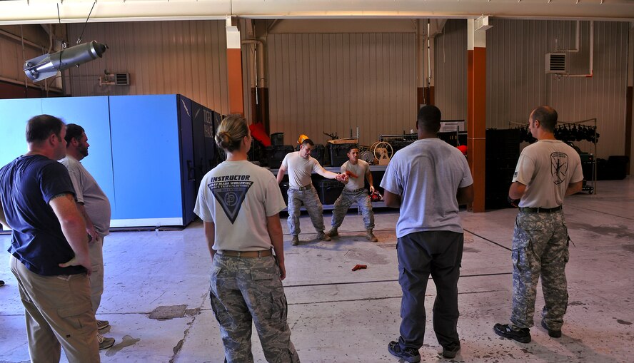 MOODY AIR FORCE BASE, Ga. -- Krav Maga instructors Senior Airmen Gabriel Rosario and Krystoffer Miller, 822nd Base Defense Squadron fire team leaders, demonstrate disarming techniques here Oct. 14. Krav Maga is a simple, effective self-defense system that emphasizes instinctive movements, practical techniques and realistic training scenarios. (U.S. Air Force photo/Airman 1st Class Joshua Green)
