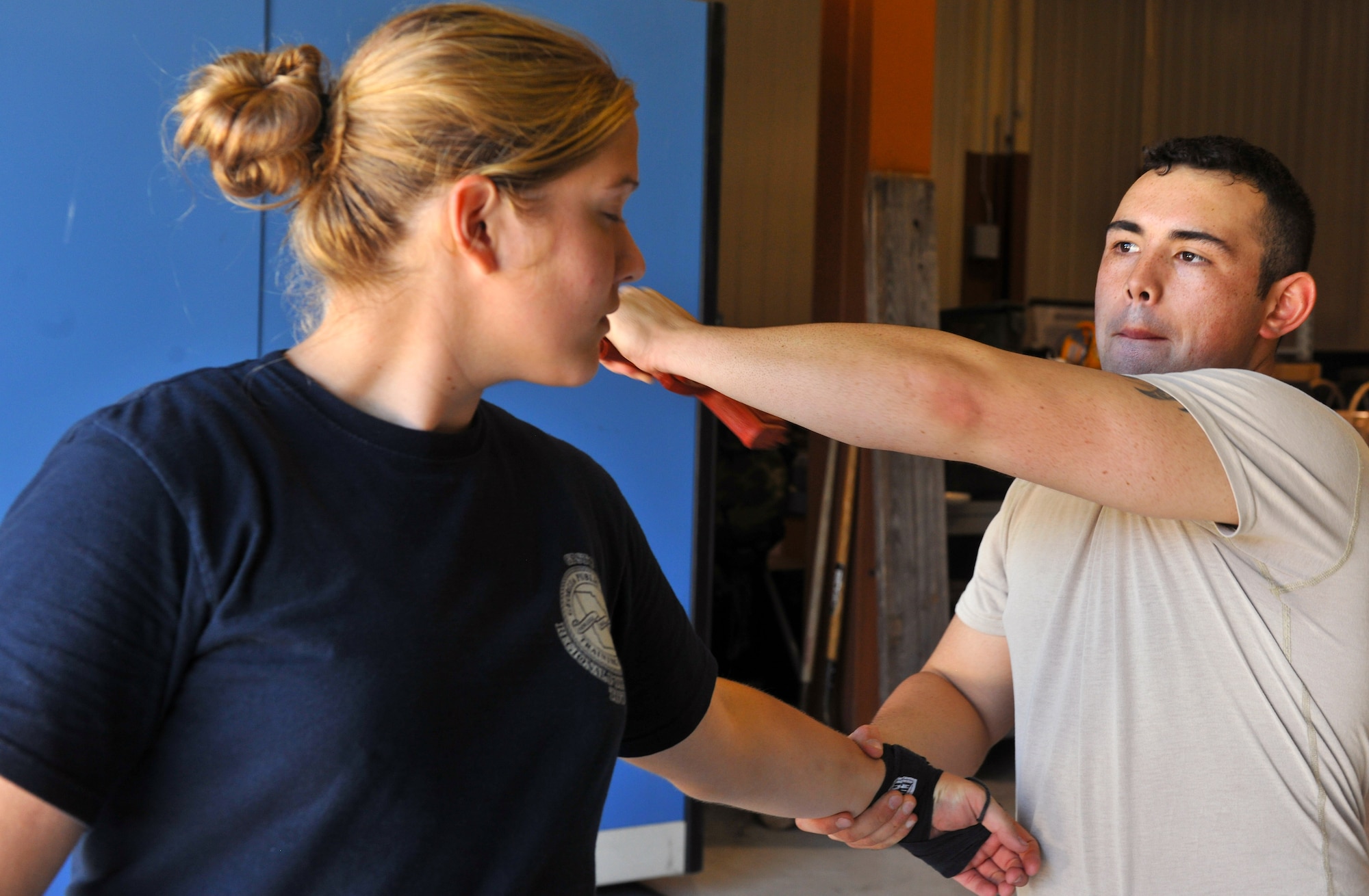 MOODY AIR FORCE BASE, Ga. -- Senior Airman Krystoffer Miller, 822nd Base Defense Squadron fire team leader, demonstrates to Felicia Pelleteri, Lowndes County Sheriff’s Department deputy, what attack you can perform after disarming an enemy here Oct. 14. Security Forces Airmen taught Krav Maga to Lowndes County Sheriff’s Department deputies and Special Weapons and Tactics members. (U.S. Air Force photo/Airman 1st Class Joshua Green)