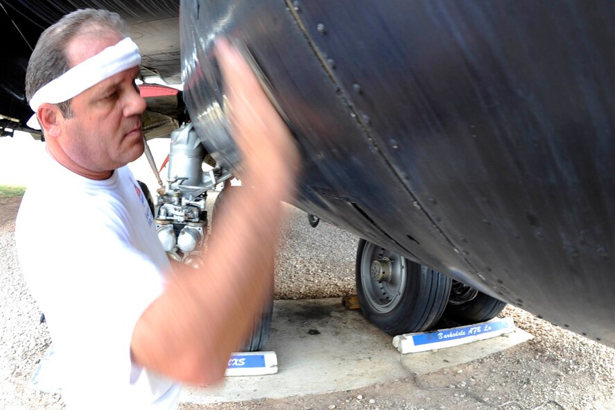 BARKSDALE AIR FORCE BASE, La. -- Contractor Jeff Roan sands off the paint of a B-52D bomber Oct. 19 at the Eighth Air Force Museum. Many contractors are working to restore the aircraft to its original paint and condition. This particular bomber flew in Operation Linebacker II during the Vietnam War. (U.S. Air Force photo/Staff Sgt. John Gordinier)