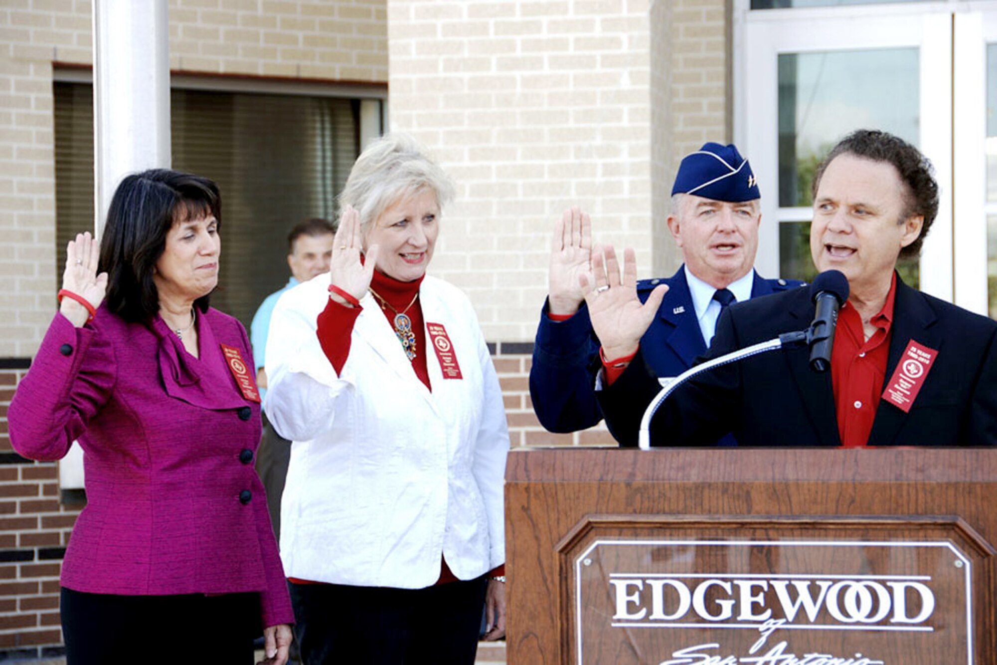 San Antonio community leaders pledge to be positive role models as they recite the Red Ribbon pledge during a news conference Oct. 18, 2010, at the Edgewood Performing Arts Theater in San Antonio. Leading the pledge is emcee and radio personality Sonny Melendrez (right,) with Maj. Gen. Thomas Travis, San Antonio District Attorney Susan Reed (left) and Dr. Elizabeth Garza, (far left). General Travis is the 59th Medical Wing commander and Mrs. Garza is the Edgewood Independent School District superintendent. (U.S. Air Force photo/Tech. Sgt. Andy Bellamy)