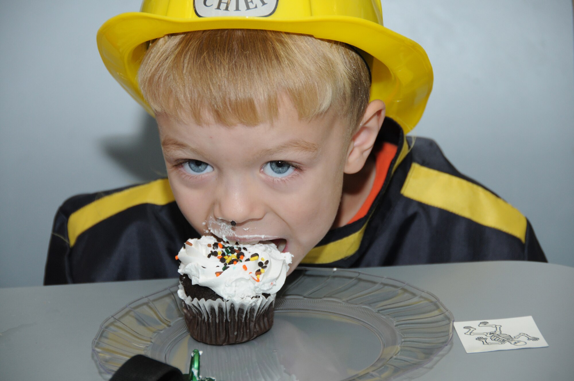Four-year-old “firefighter” Alex Runquist, son of Tech. Sgt. Adam and Amanda Runquist, 81st TRW, enjoys a cupcake. (U.S. Air Force photo by Kemberly Groue)