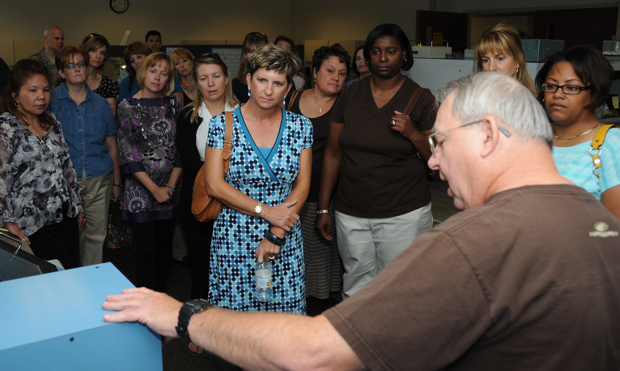 Mary Fitzgerald, center, and other members of the Keesler Spouses Club learn about a command post trainer simulator from Woody Wilson, 81st Training Support Squadron electronic design engineer, at the trainer development facility during an 81st Training Group tour Oct. 14.  Mrs. Fitzgerald’s husband is Col. Jay Fitzgerald, 2nd Air Force.  (U.S. Air Force photo by Kemberly Groue)
