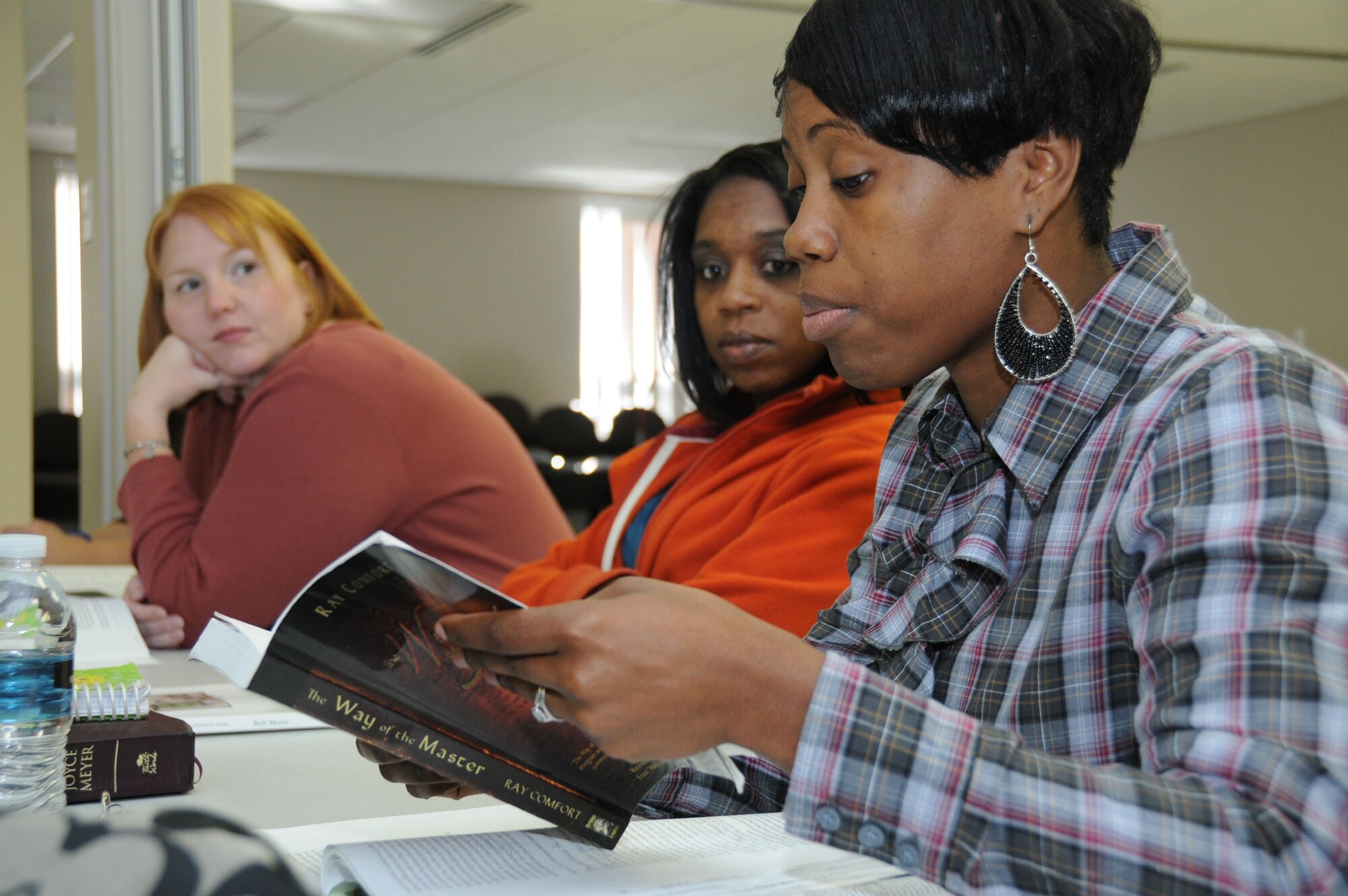From left, Christie Johnson and Tiffany Bell listen as LaShae Snider shares her insight into “The Way of the Master” by Ray Comfort, the book being studied at the Oct. 6 women’s Bible study at the Triangle Chapel Annex. Mrs. Johnson is the wife of retired Coast Guard Senior Chief Harry Johnson, Mrs. Bell is the wife of retired Master Sgt. Kenneth Bell, and Mrs. Snider is the wife of Master Sgt. Wendell Snider, 366th Training Squadron Detachment 6 at the Seabee Base in Gulfport.  (U.S. Air Force photo by Kemberly Groue)