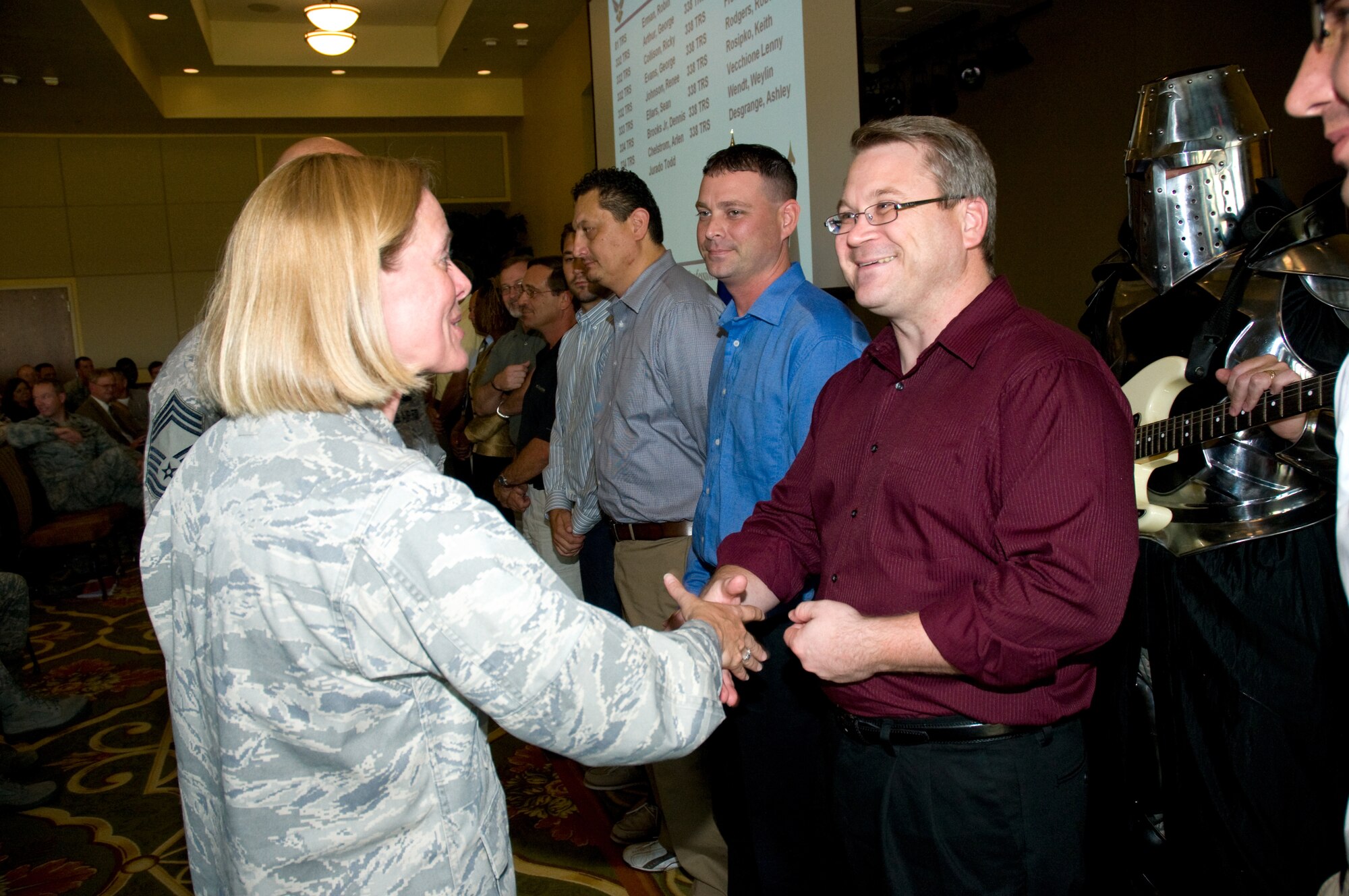 Col. Lynn Connett, left, 81st Training Group commander, welcomes George Arthur,
332nd Training Squadron, as a new civilian employee during a pinning ceremony Oct. 14 at the Bay Breeze Event Center. Mr. Arthur is one of 19 civilian employees from the 81st TRG who recently completed the NEO course.  (U.S. Air Force photo by Adam Bond)