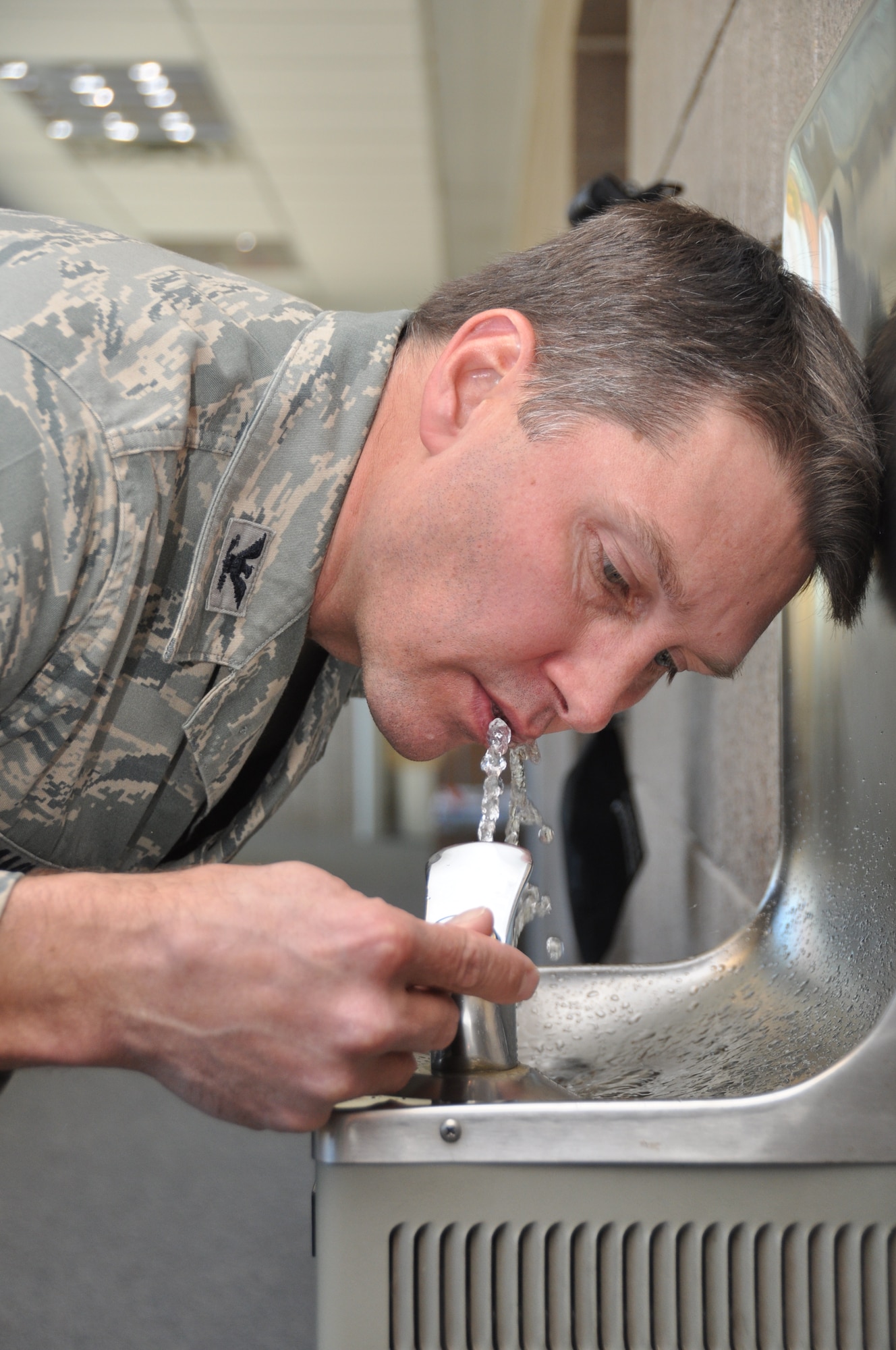 Col. Toby Hammer, 934th Airlift Wing inspector general, takes a drink from one of the base fountains. (Air Force Photo/Senior Airman Noah Johnson)