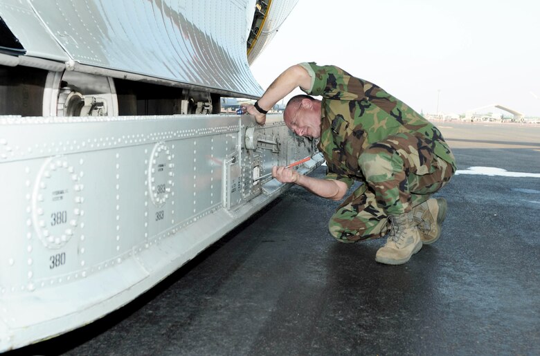 Master Sgt. Joseph Sinatra checks the air spring pressure on an LC-130 Hercules during a stop Oct. 18, 2010, at Hickam Air Force Base, Hawaii. The springs are used to absorb the shock of landing the ski-equipped aircraft on the Antarctic ice. Sergeant Sinatra and the rest of his LC-130 aircrew stopped at Hickam while en route to Antarctica to support Operation Deep Freeze, the Defense Department?s logistical support to U.S. research activities at the southernmost continent. Sergeant Sinatra is an LC-130 crew chief assigned to the New York Air National Guard's 109th Airlift Wing at Stratton Air National Guard Base, N.Y. (U.S. Air Force photo/Tech. Sgt. Kerry Jackson) 