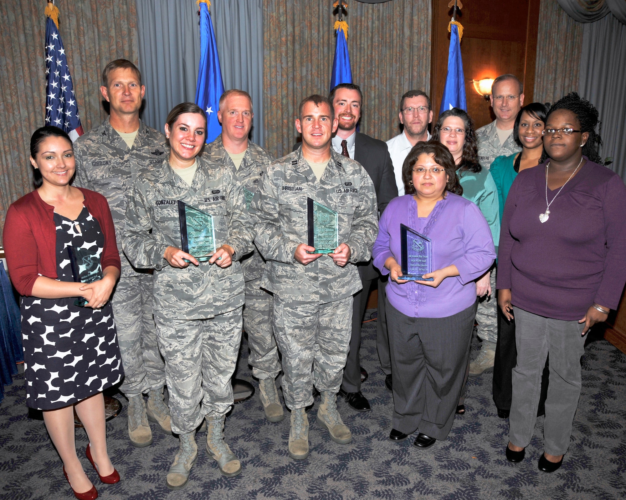 The HQ AFDW Third Quarter Awards winners were recognized at The Club, Andrews AFB, Md., Oct 20, 2010. From left to right:  Category II Civilian of the Quarter, Ms. Melissa Rivera-Weedin, AFDW Contracting; Air Force District of Washington Vice Commander Col. Phillip Gibbons stands with the AFDW Quarterly Award Winners; Airman of the Quarter, Airman 1st Lizzie Gonzalez, AFDW/Manpower and Personnel; SNCO of the Quarter, Master Sgt. Douglas Adams, AFDW/Accounting and Finance; CGO of the Quarter, Capt. Ty Christian, AFDW/Contracting; Category I Civilian of the Quarter, Mr. Brian Halston, AFDW/Contracting; AFDW Team of the Quarter, Vendor Pay Team, Mr. Richard Dillow, Ms. Charlotte Smith, Ms. Mary Logan, Ms. Star Lewis, and Ms. Telena  Henderson, AFDW/Accounting and Finance; AFDW Command Chief Master Sgt. Pat Battenberg. Not pictured is the NCO of the Quarter Staff Sgt Tonya Barrow, AFDW/ Lessons Learned.   (U.S. Air Force photo by Staff Sgt. Christopher Marasky)

