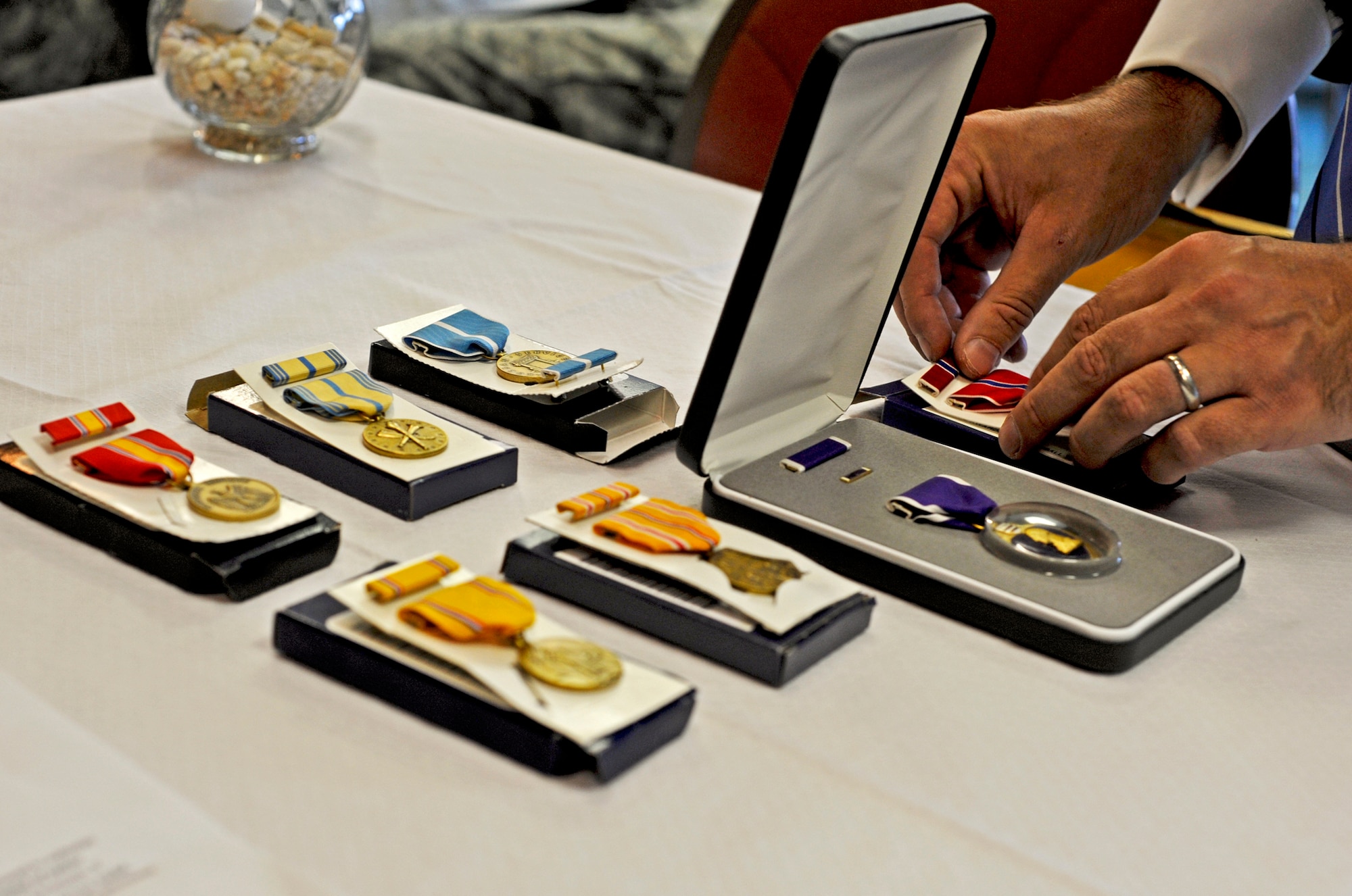 Medals are delicately placed on a table prior to their presentation to 89-year-old Charles “Buster” Donnell at the Air Force Enlisted Village, Oct 20.  He received the Bronze Star, Purple Heart, Armed Forces Reserve Medal, Asiatic-Pacific Campaign Medal, Korean Service Medal, American Defense Medal and National Defense Service Medal.  Mr. Donnell served in the Army in World War II, but later joined the Air Force.  He retired from active duty in 1962.  (U.S. Air Force photo/Samuel King Jr.)