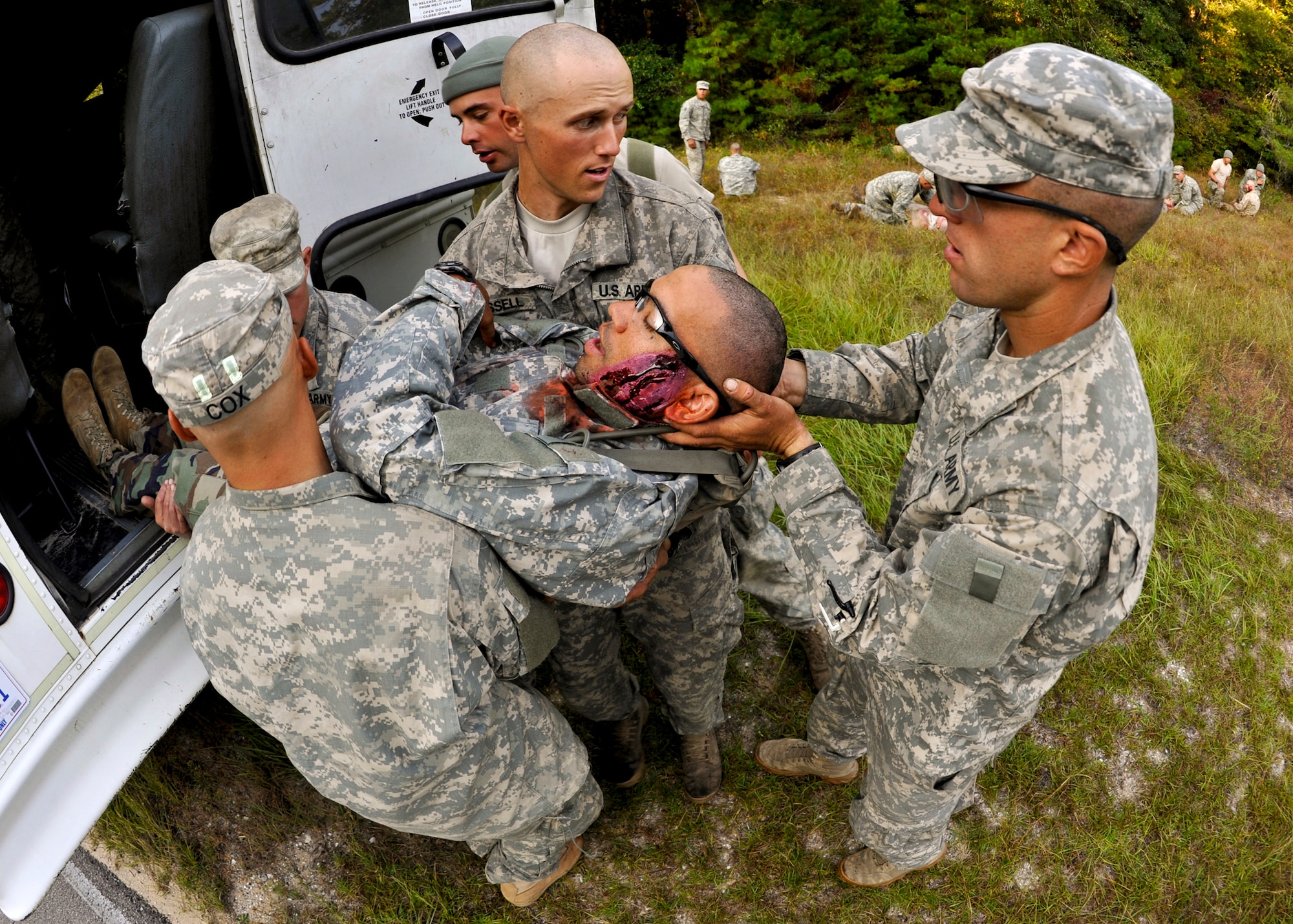Army Rangers remove a victim from the back of the bus following a simulated bus accident Oct. 19 at the entrance to their camp on Eglin Air Force Base. The no-notice exercise simulated an accident involving two cyclists and a bus transporting 6th Ranger Training Battalion students. Soldiers following in the other buses reacted quickly to secure the scene while getting medical support from Eglin and local emergency crews.  (U.S. Air Force photo/Samuel King Jr.)