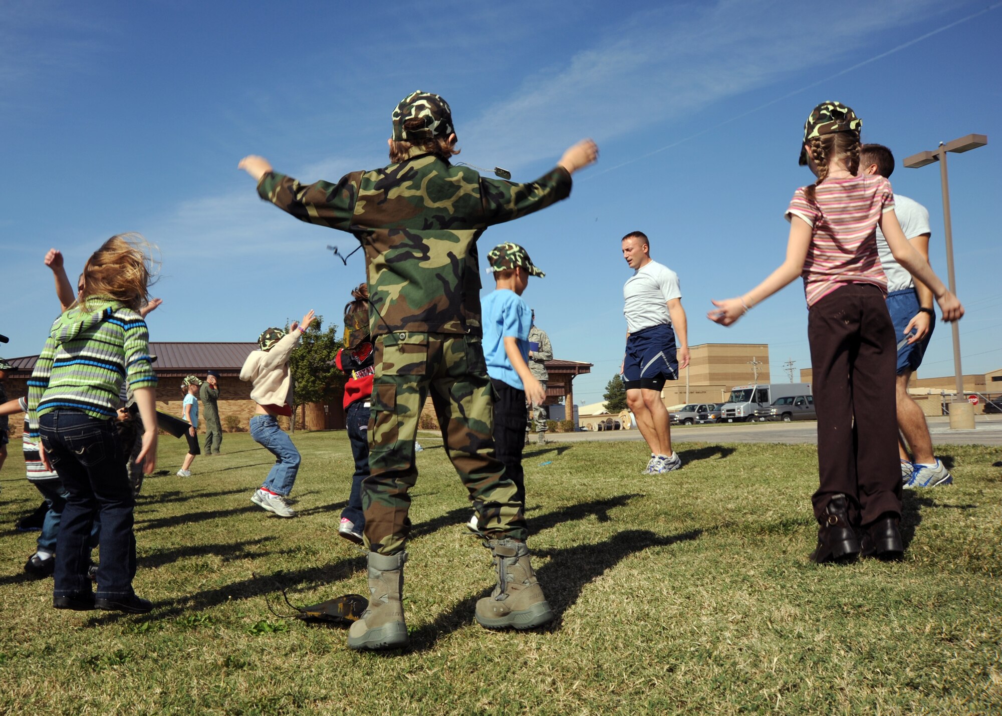 McConnell children perform physical exercises to learn the importance of physical fitness in the military during the Family Mobility Line, Oct. 16, 2010, McConnell Air Force Base, Kan.  The event shared the deployment process with family members.  (U.S. Air Force photo/Airman 1st Class Andrea Salazar)