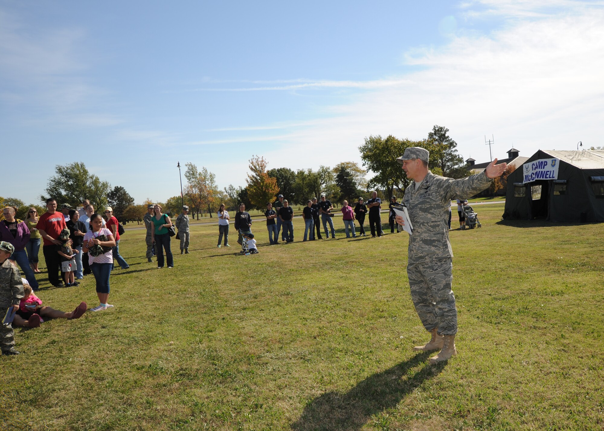 Col. Jamie Crowhurst, 22nd Air Refueling Wing commander, greets children arriving to “Camp McConnell” and gives instructions for the mission they must complete while “deployed,” during the Family Mobility Line, Oct. 16, 2010, McConnell Air Force Base, Kan.  While at Camp McConnell, children had to “qualify” at the mock range, perform physical exercise, try on gas masks and eat a boxed lunch in order to get a fun and safe experience of what their parents experience while preparing to deploy.  (U.S. Air Force photo/Airman 1st Class Andrea Salazar)
