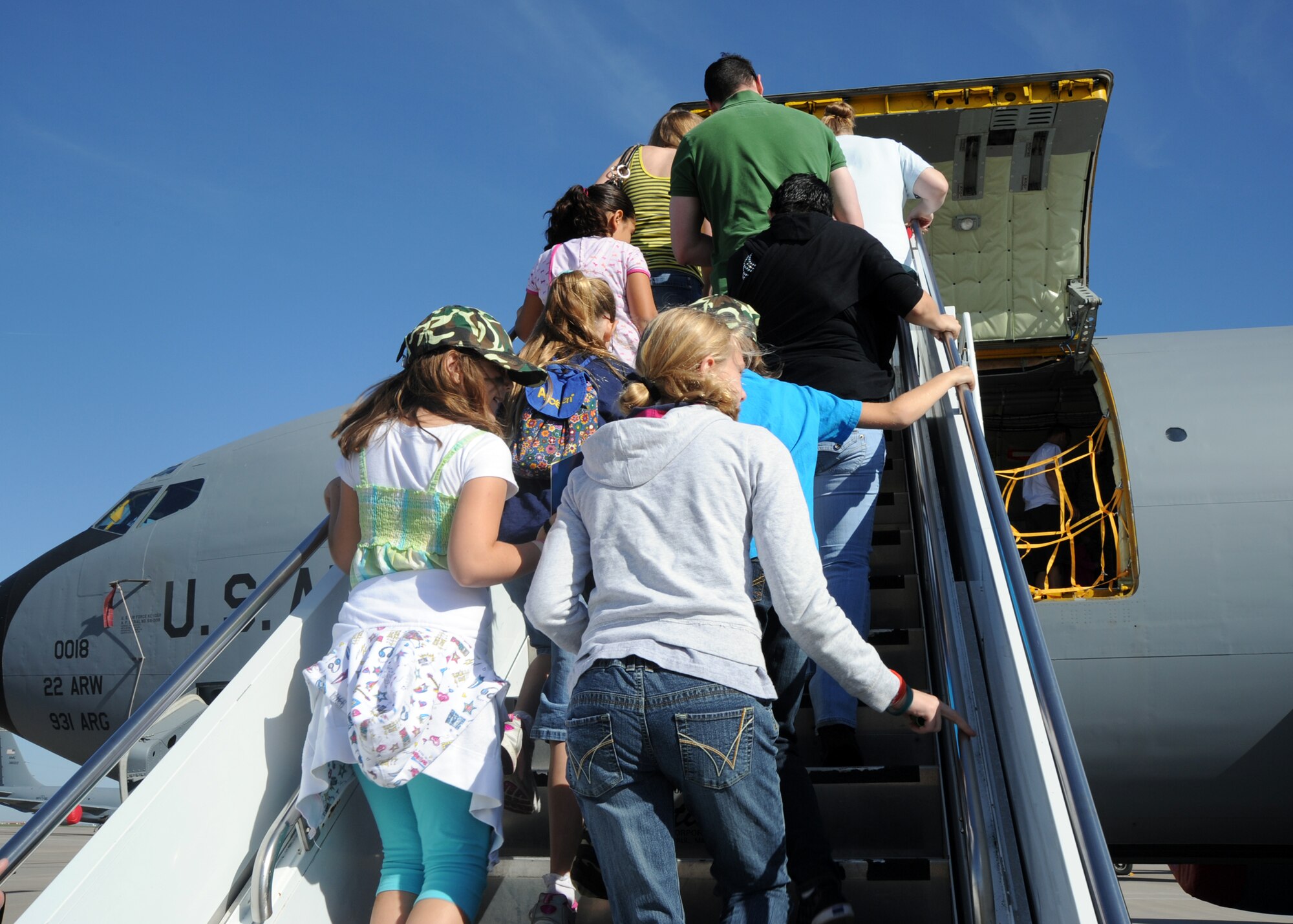 McConnell family members board a KC-135 Stratotanker as part of the Family Mobility Line Oct. 16, 2010, McConnell Air Force Base, Kan.  The event was hosted by the Airman and Family Readiness Center to help family members understand the many aspects of the military and what their parents experience before deploying.  (U.S. Air Force photo/Airman 1st Class Andrea Salazar)
