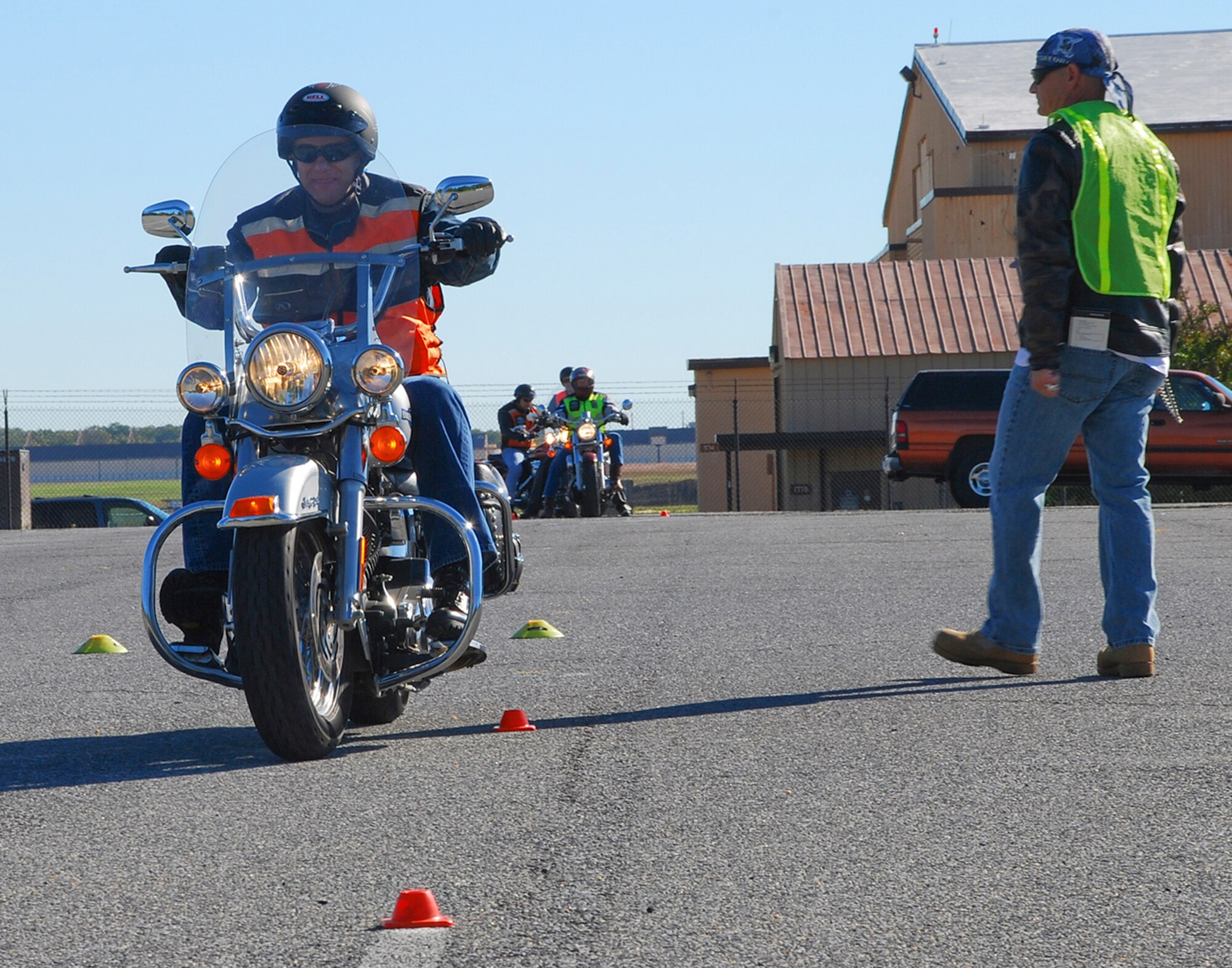 Lieutenant General Philip M. Breedlove, Deputy Chief of Staff for Operations, Plans and Requirements, Headquarters U.S. Air Force, Washington, D.C., rides past an instructor during the Experienced Motorcycle Safety Course here Oct. 16. The course, hosted by the 11th Wing Safety Office, offers a mixture of classroom and hands-on instruction geared toward more advanced riders who own motorcycles.  (U.S. Air Force photo/Senior Airman Amber Russell)