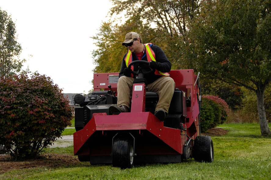 HANSCOM AIR FORCE BASE, Mass. – Charlie Harris mows the lawn around the clinic on Oct. 12. Grounds keeping services resumed across the base last week. Base personnel will notice continued upkeep as more leaves fall in autumn and snow falls in winter. (U.S. Air Force photos by Linda LaBonte Britt)