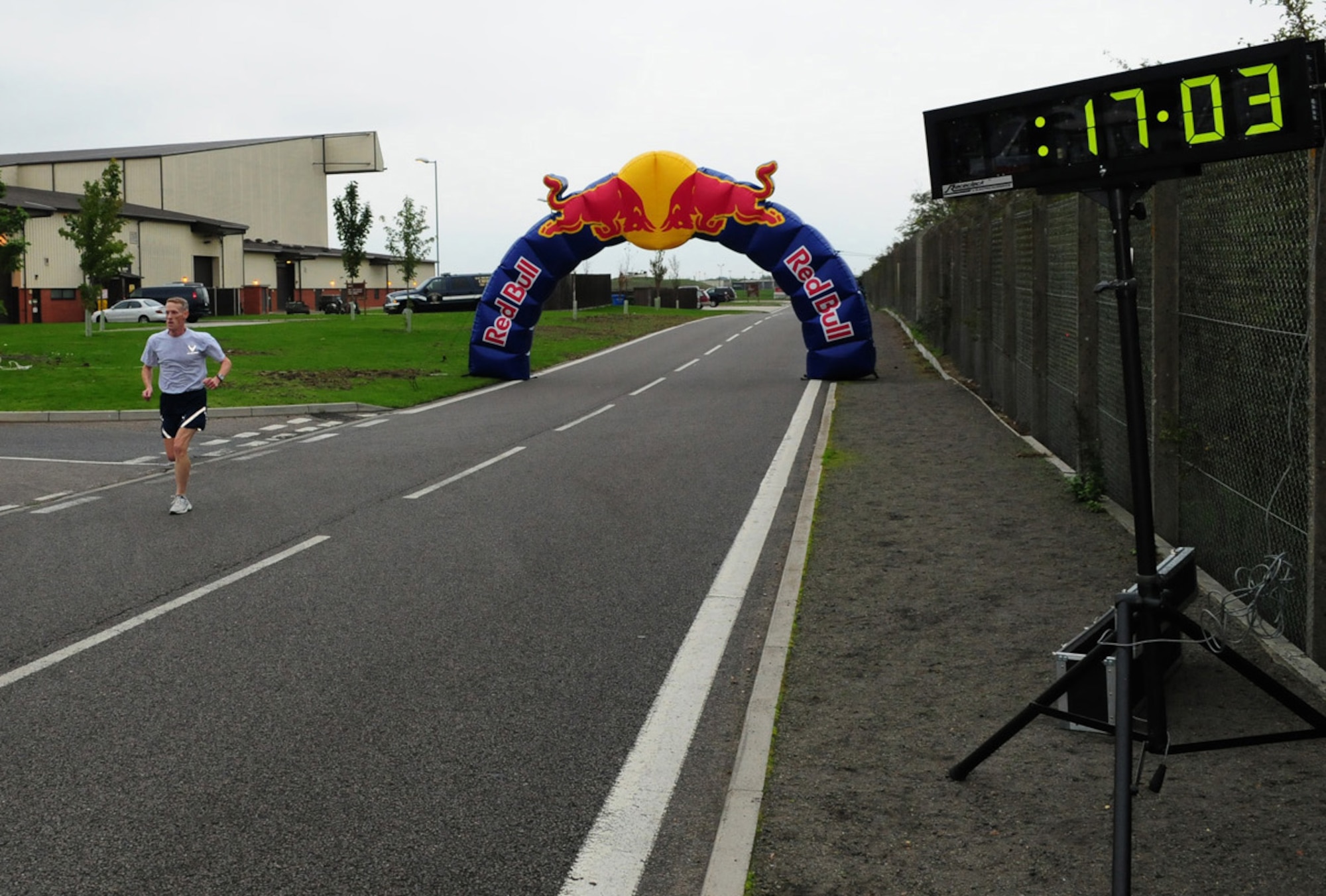 RAF MILDENHALL, England -- Lt. Col. Chris Bennett, 100th Air Refueling Wing, prepares to cross the finish line and takes an easy first place with a time of 17:04 at the wing 5K run Oct. 15. Second place was Capt. Peter Shayhorn, 351st Air Refueling Squadron, and third place was Maj. David Wieland, 100th ARW. Placing first in the female category was Staff Sgt. Danielle Todman, 100th Force Support Squadron, and second was Senior Airman Amanda Martin, 100th Communications Squadron. (U.S. Air Force photo/Karen Abeyasekere)