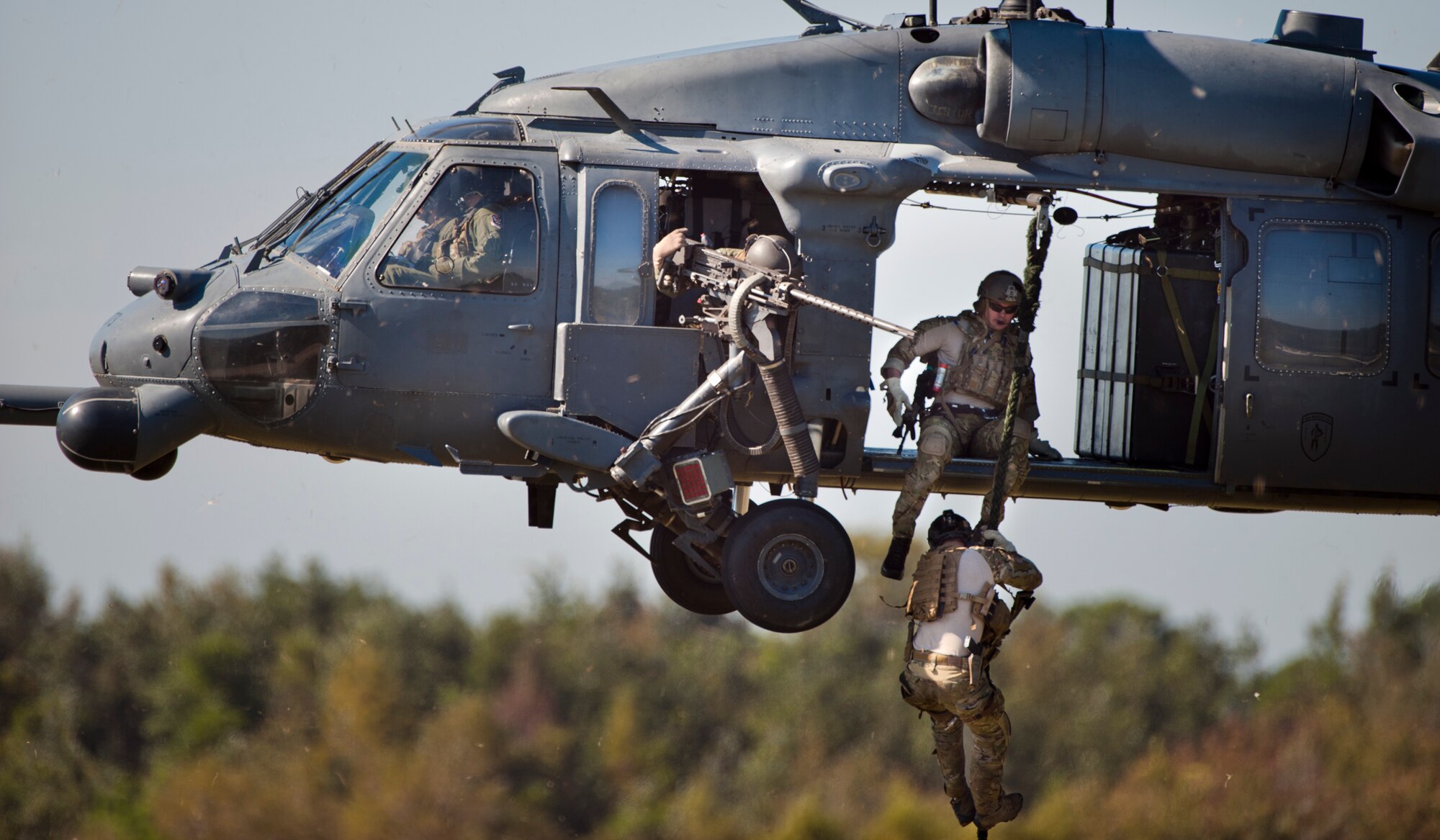 MOODY AIR FOREC BASE, Ga. -- Pararescuemen from the 38th Rescue Squadron exit an HH-60G Pave Hawk helicopter from the 41st Rescue Squadron during a combat demonstration Oct. 18 at the Grand Bay Bombing and Gunnery Range. Along with the 71st Rescue Squadron, the two squadrons worked together to demonstrate their ability to rescue a downed pilot. (U.S. Air Force photo/Senior Airman Jamal D. Sutter)