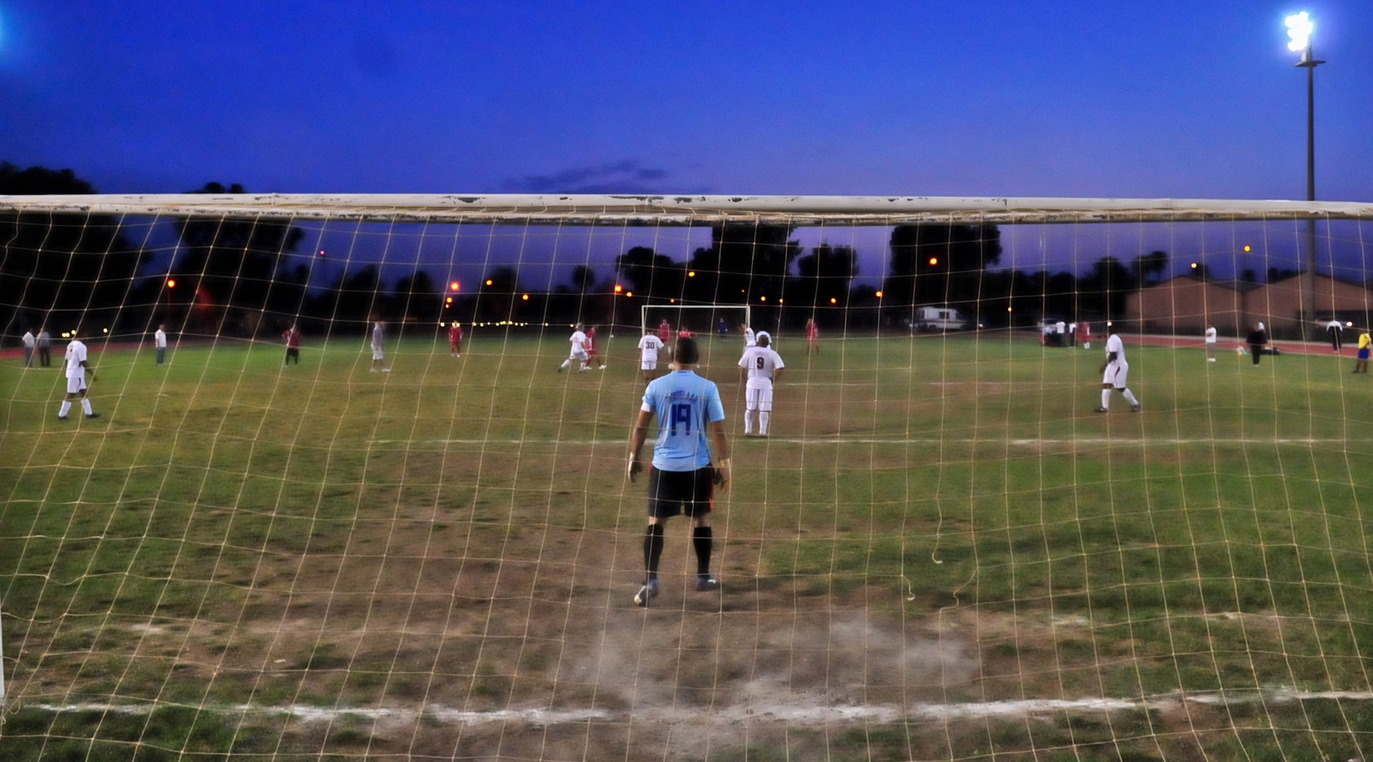 U.S., white jerseys, and Turkish Airmen at Incirlik Air Base, Turkey competed against each other during a semifinal soccer match Oct. 19, 2010. The game was part of an annual soccer tournament that included 11 Turkish teams and one U.S. team. The Turkish team won the game 5-4 and advanced to the finals scheduled for Oct. 22. (U.S. Air Force Photo/ Senior Airman Alexandre Montes/Released)