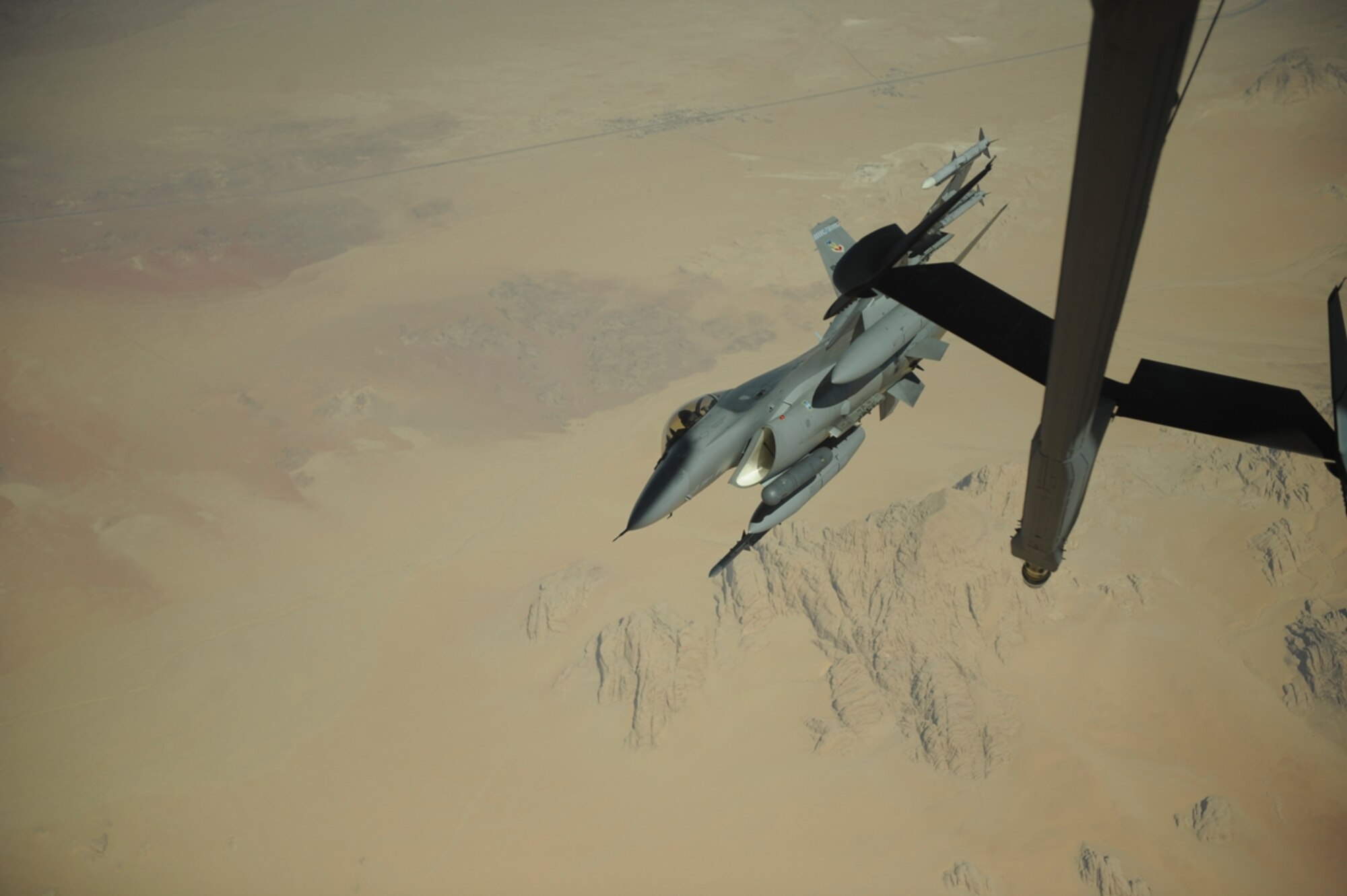 A U.S. Air Force F-16 Fighting Falcon from the 77th Fighter Squadron, Shaw Air Force Base, S.C., moves into formation after receiving fuel from a KC-10 Extender from the 2nd Air Refueling Squadron, Joint Base McGuire, N.J., as part of The Falcon Air Meet 2010 near Azraq Air Base, Jordan, Oct. 20, 2010.  The purpose of The Falcon Air Meet is to improve international military relations and joint air operations.  (U.S. Air Force Photo/Staff Sgt. Eric Harris)