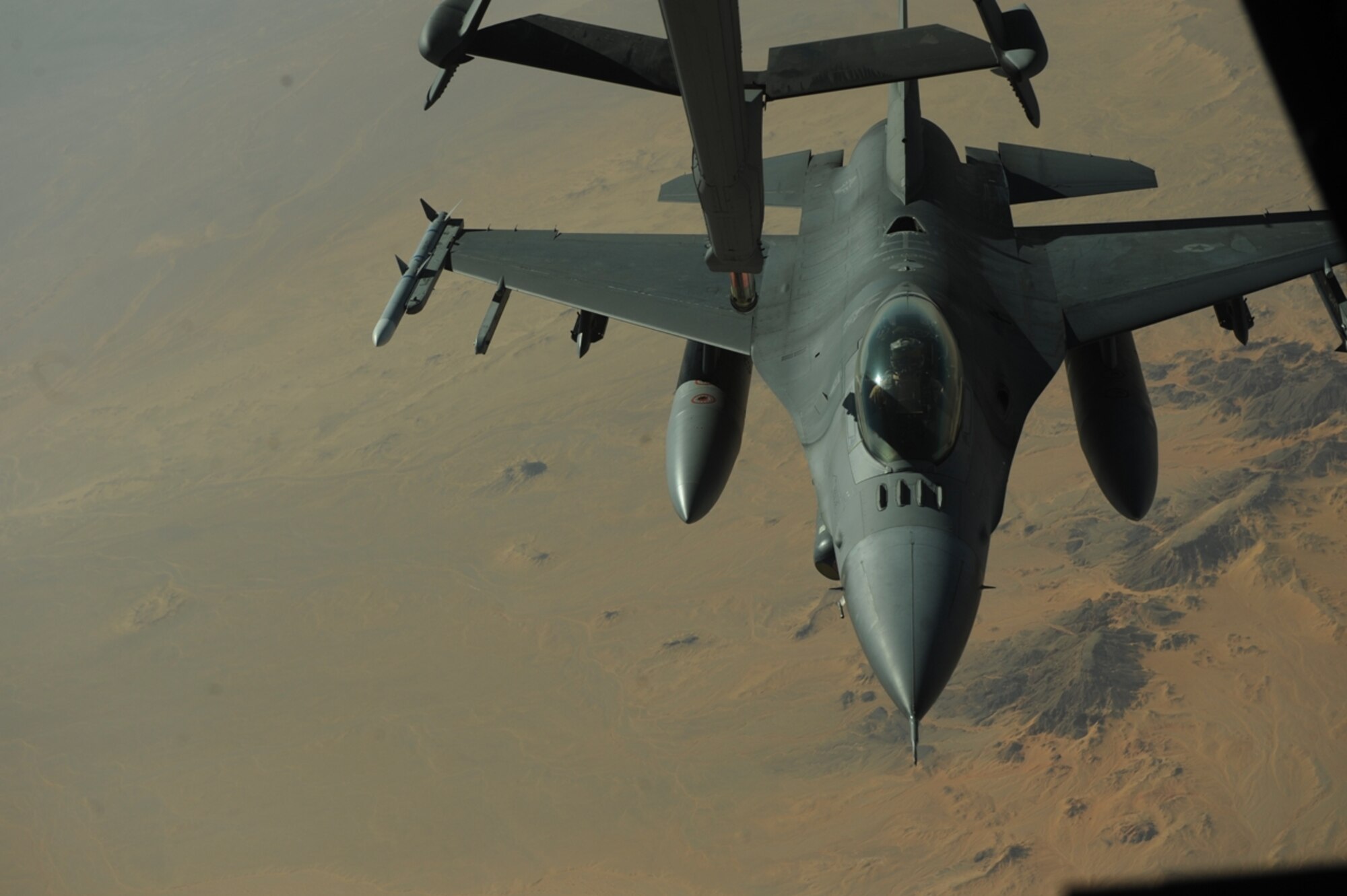 A U.S. Air Force F-16 Fighting Falcon from the 77th Fighter Squadron, Shaw Air Force Base, S.C., maneuvers into position behind a KC-10 Extender from the 2nd Air Refueling Squadron, Joint Base McGuire, N.J., as part of The Falcon Air Meet 2010 near Azraq Air Base, Jordan, Oct. 20, 2010.  The purpose of The Falcon Air Meet is to improve international military relations and joint air operations.  (U.S. Air Force Photo/Staff Sgt. Eric Harris)