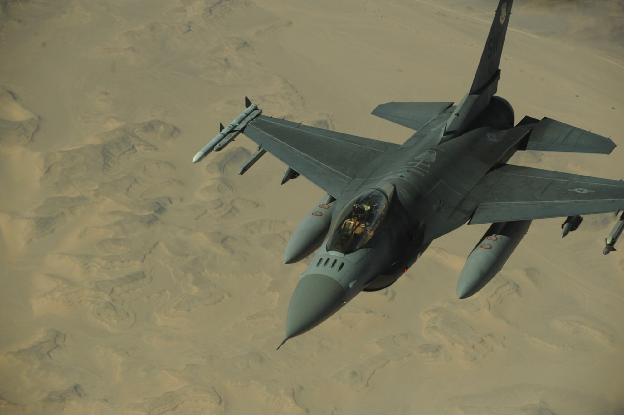 A U.S. Air Force F-16 Fighting Falcon from the 77th Fighter Squadron, Shaw Air Force Base, S.C., moves into formation after receiving fuel from a KC-10 Extender from the 2nd Air Refueling Squadron, Joint Base McGuire, N.J., as part of The Falcon Air Meet 2010 near Azraq Air Base, Jordan, Oct. 20, 2010.  The purpose of The Falcon Air Meet is to improve international military relations and joint air operations.  (U.S. Air Force Photo/Staff Sgt. Eric Harris)