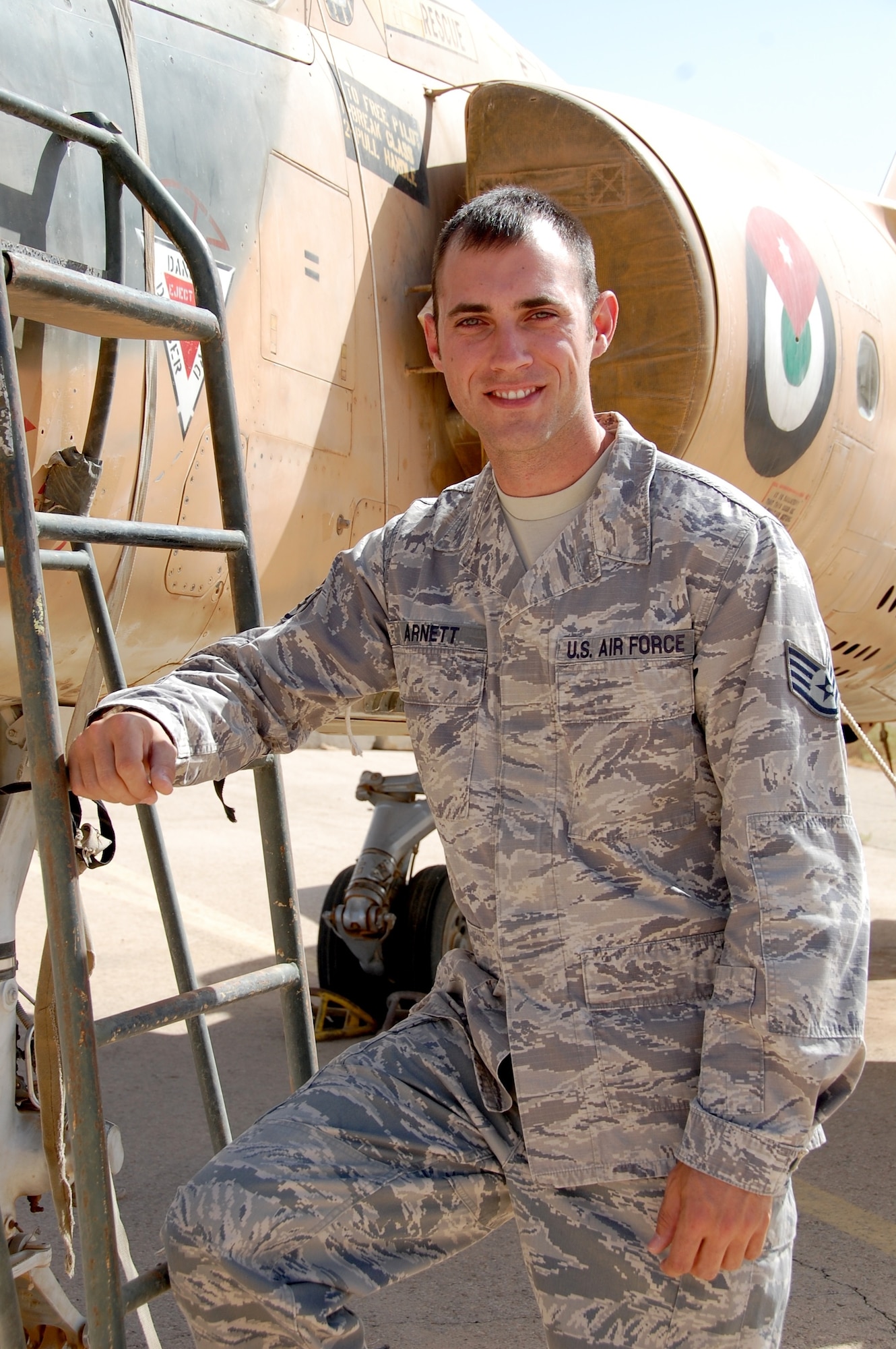 Staff Sgt Josh R. Arnett, 28, 5th Combat Communications Group, is deployed as part of the U.S. Air Force contingent to Falcon Air Meet 2010. Arnett is on his third deployment and took some time to check out an Royal Jordanian Air Force Mirage, no longer in use, on the base’s flight line. (U.S. Air Force Photo by Mr. Alan Black)