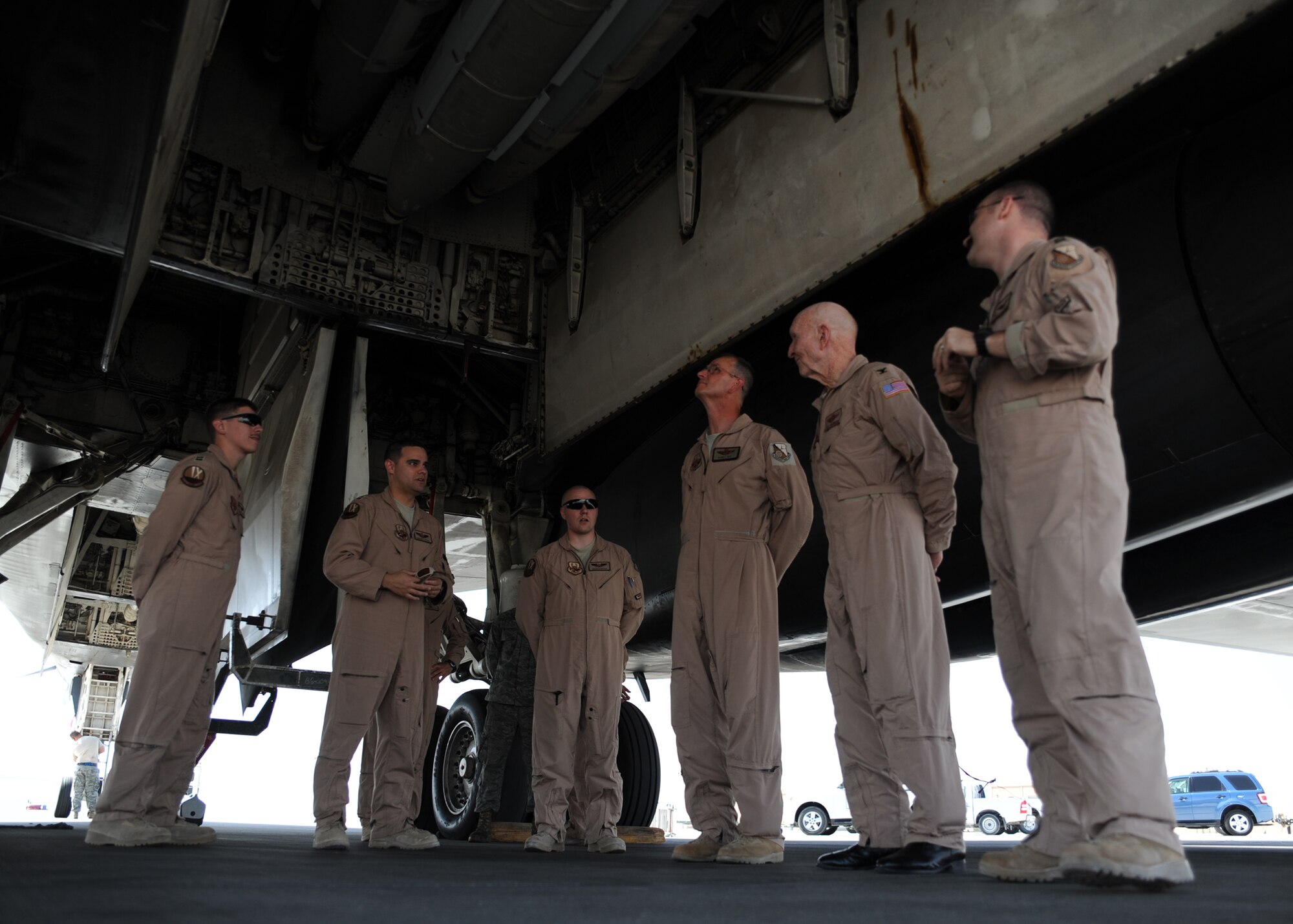 Retired Col. Gail Halvorsen, the "Candy Bomber," is briefed by aircrew on the B-1B at an undisclosed location in Southwest Asia, Oct. 21.The airlift icon is touring Europe and Southwest Asia this week to encourage servicemembers and teach them about the evolution of military heritage. (U.S. Air Force photo/Senior Airman Katie Gieratz)(RELEASED) 