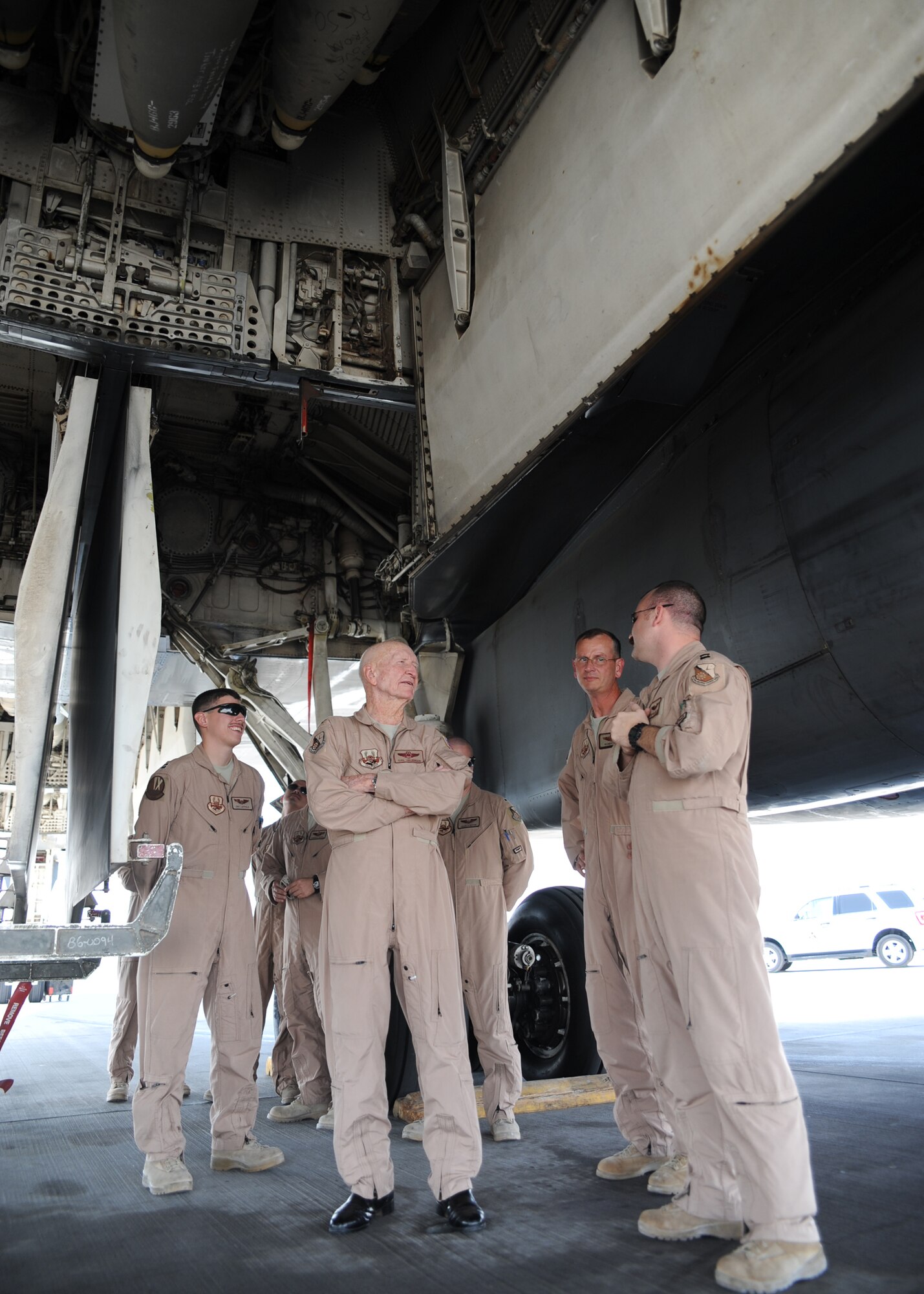 Retired Col. Gail Halvorsen, the "Candy Bomber," is briefed by aircrew on the B-1B at an undisclosed location in Southwest Asia, Oct. 21. The Berlin Airlift veteran is known for his role in strengthening U.S.-German ties after a goodwill gesture of air dropping candy bars to children in East Berlin. His efforts evolved into a full-scale operation ending in more than 20 tons of candy delivered via small parachutes. (U.S. Air Force photo/Senior Airman Katie Gieratz)(RELEASED) 