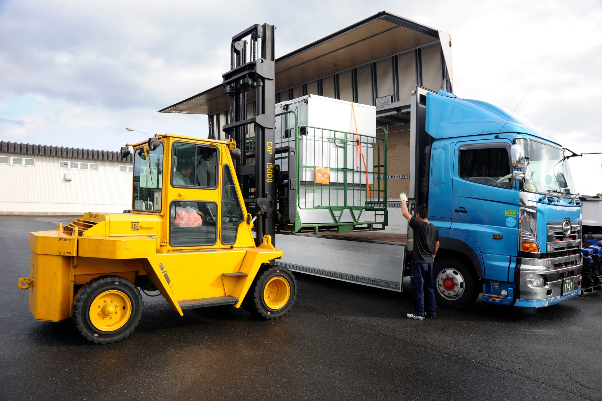 Yukie Yoshida drives a 15000-lb fork lift for the Defense Reutilization and Marketing Office, placing large pallets on to  a truck bed at Misawa Air Base, Japan, Oct. 21, 2010. The load of 60 refrigerators weighed 5,200 pounds. (U.S. Air Force photo by Tech. Sgt. Russell McBride/Released)