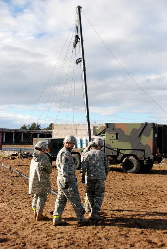 U.S. soldiers and airmen set up the broadcast antenna for the American Forces Network Europe Tactical Mobile Radio and Television System during Exercise Saber Strike, a U.S. Army Europe event, in Adazi Training Area, Latvia, Oct. 18, 2010.