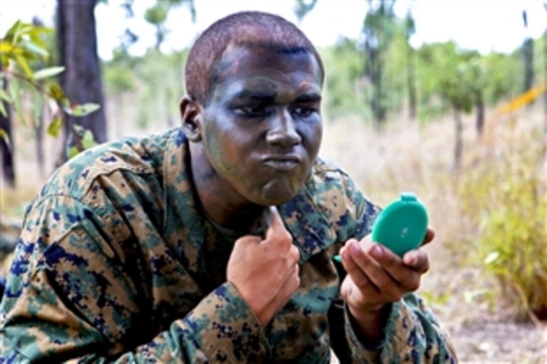 U.S. Marine Corps Lance Cpl. Michael Ellmer applies camouflage paint during Exercise Hamel on the Townsville Training Area, Australia, Oct. 12, 2010. U.S. Marines assigned to the 3rd Marine Regiment are supporting the annual exercise, which is designed to enhance the Australian Army's ability to fight and operate in a modern, complex battlespace. Ellmer is assigned to Alpha Company, 1st Battalion, 3rd Marine Regiment.