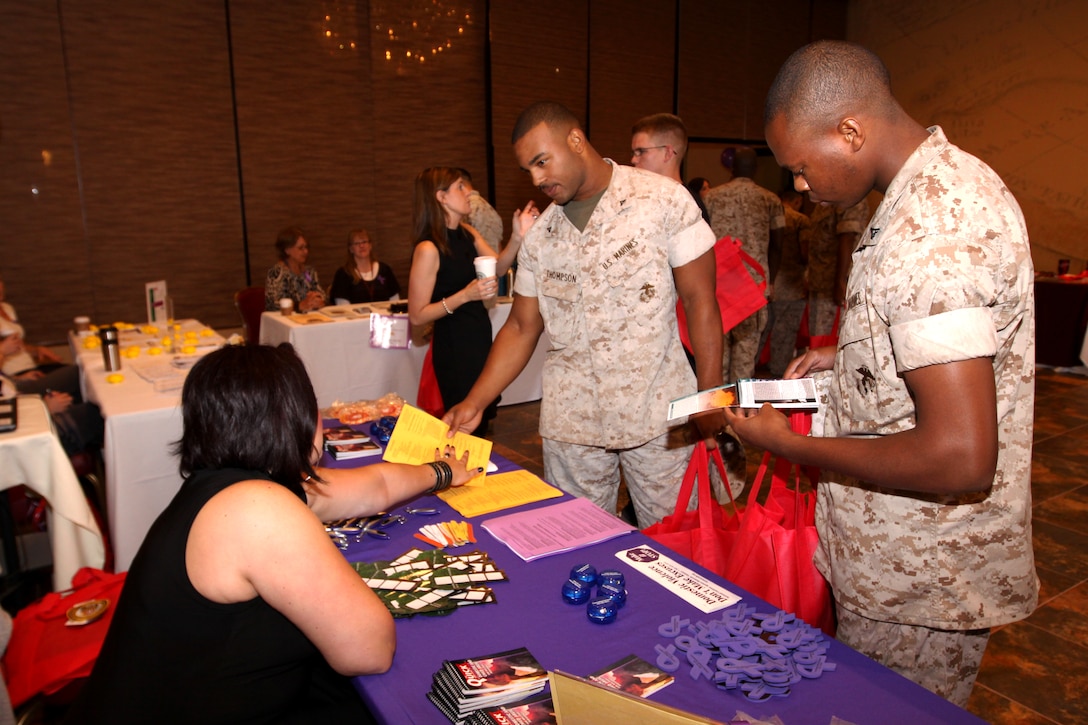 (Left to right) Carolina A. Yepez, victim advocate, Marine Corps Community Services Counseling Services, informs Lance Cpls. Charles X. Thompson and Marcus D. French, both aviation technicians with Marine Aviation Logistics Squadron 39, 3rd Marine Air Wing, about the services her organization can offer service members during the 3rd Annual Family Legacy and Leadership Expo at Camp Pendleton’s South Mesa Club, Oct. 21. The event featured 19 different organizations that offer various support programs for service members on base.