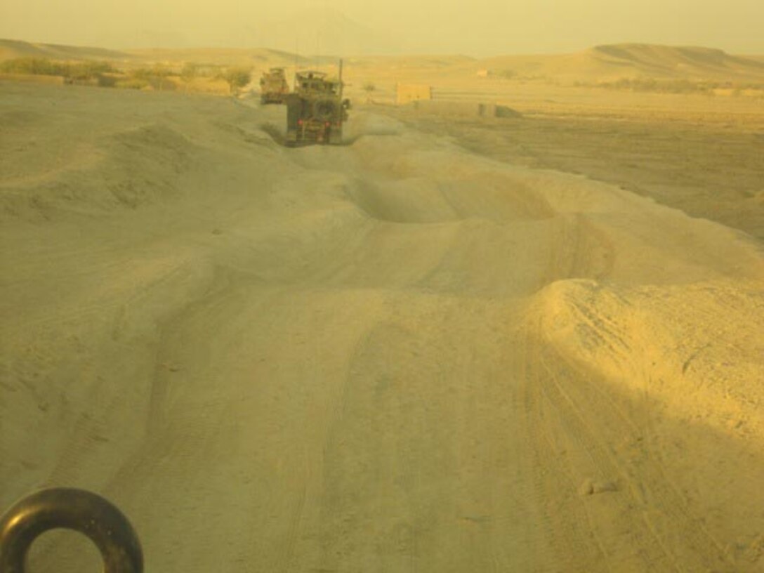 ‘It looked more like a roller coaster ride in some areas,’ said Capt. Curtiss Peck of the deep ruts in the road near the village of Shir Ghazay before Marines with 9th Engineer Support Battalion, 1st Marine Logistics Group (Forward) completed road improvements. The Marines spent several days improving the road as well as installing new culverts to aid in the crossing of dried river beds, or wadis.