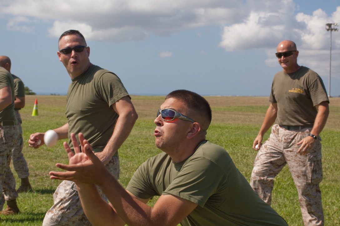 Lance Cpl. Danny Chunn, percussionist with the U.S. Marine Corps Forces, Pacific Band, catches an egg during the egg toss competition during a family day and field meet at Bordelon Field Oct. 22. Marines, sailors and their families were invited to enjoy a day of fun, including music, competitive games and food.